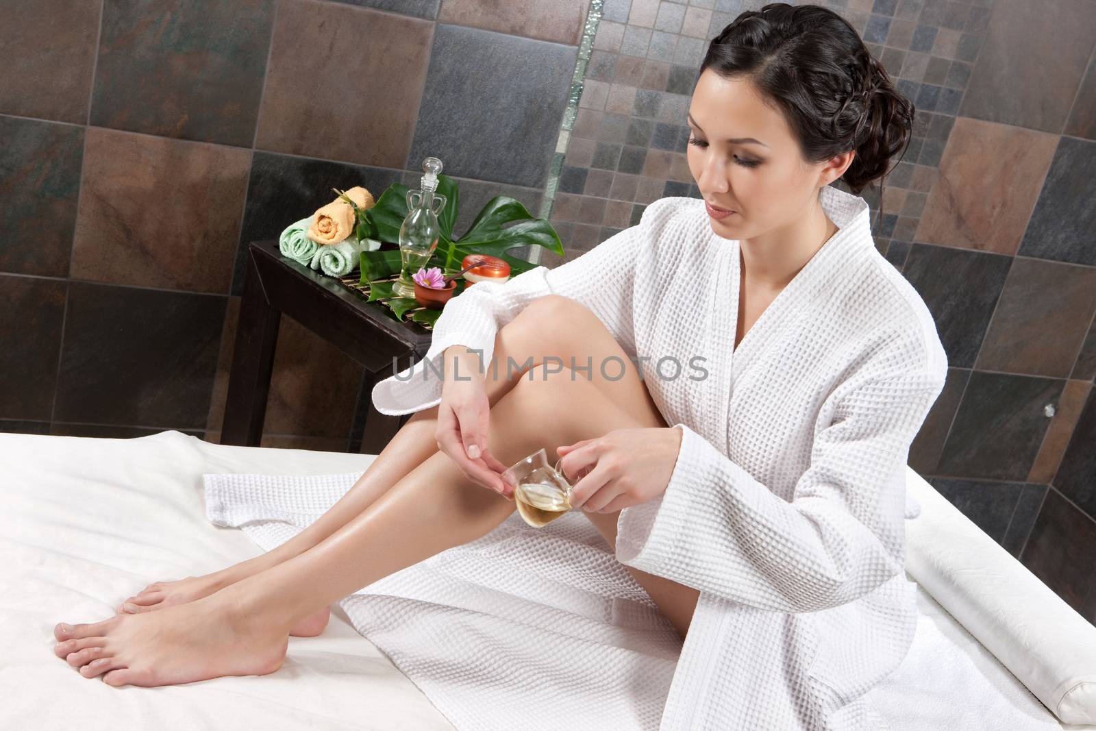 Young attractive woman taking massage and spa procedures