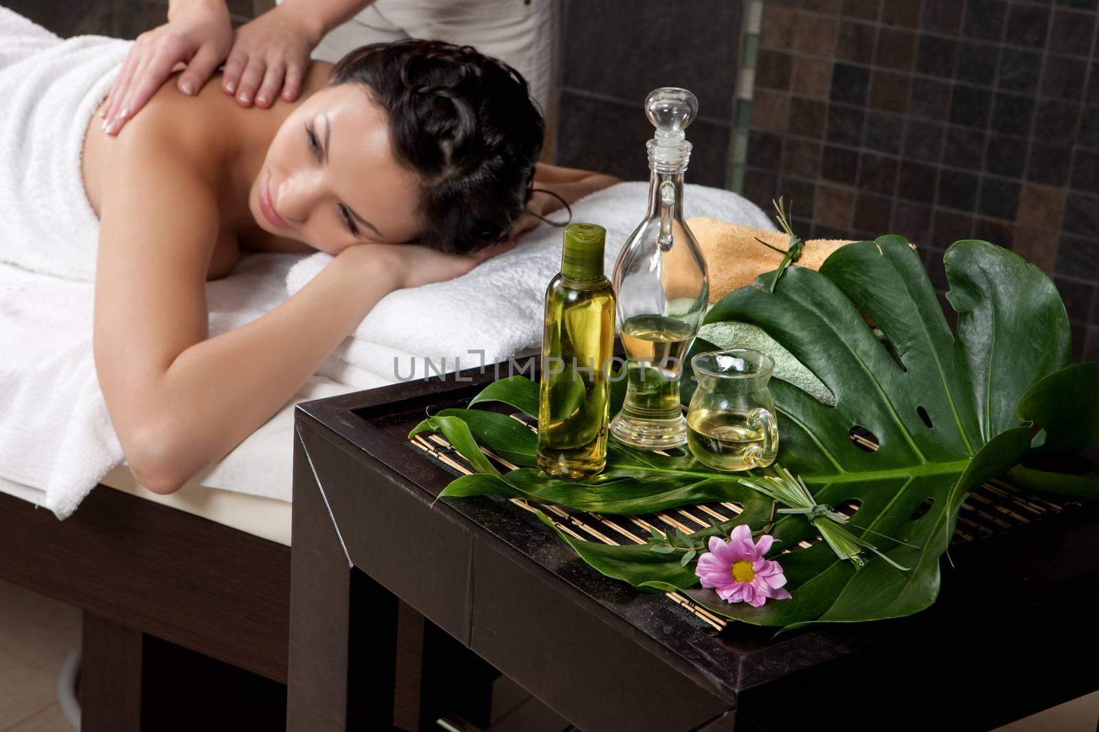 Young attractive woman taking massage and spa procedures