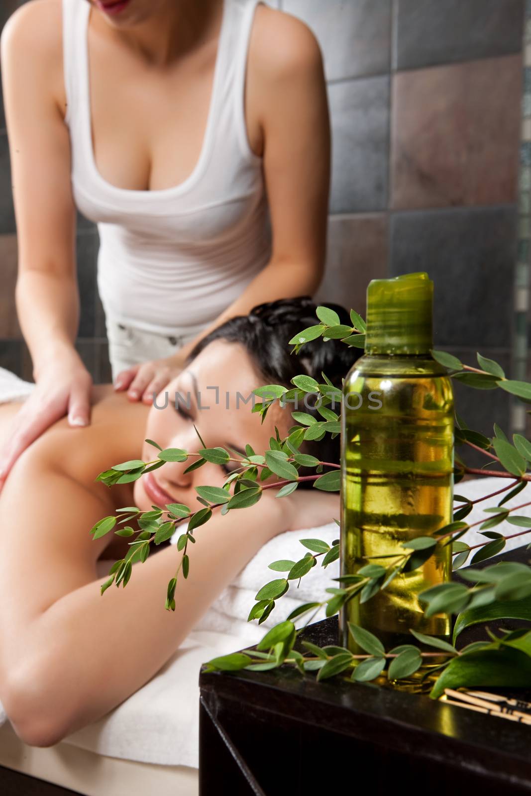 Young attractive woman taking massage and spa procedures