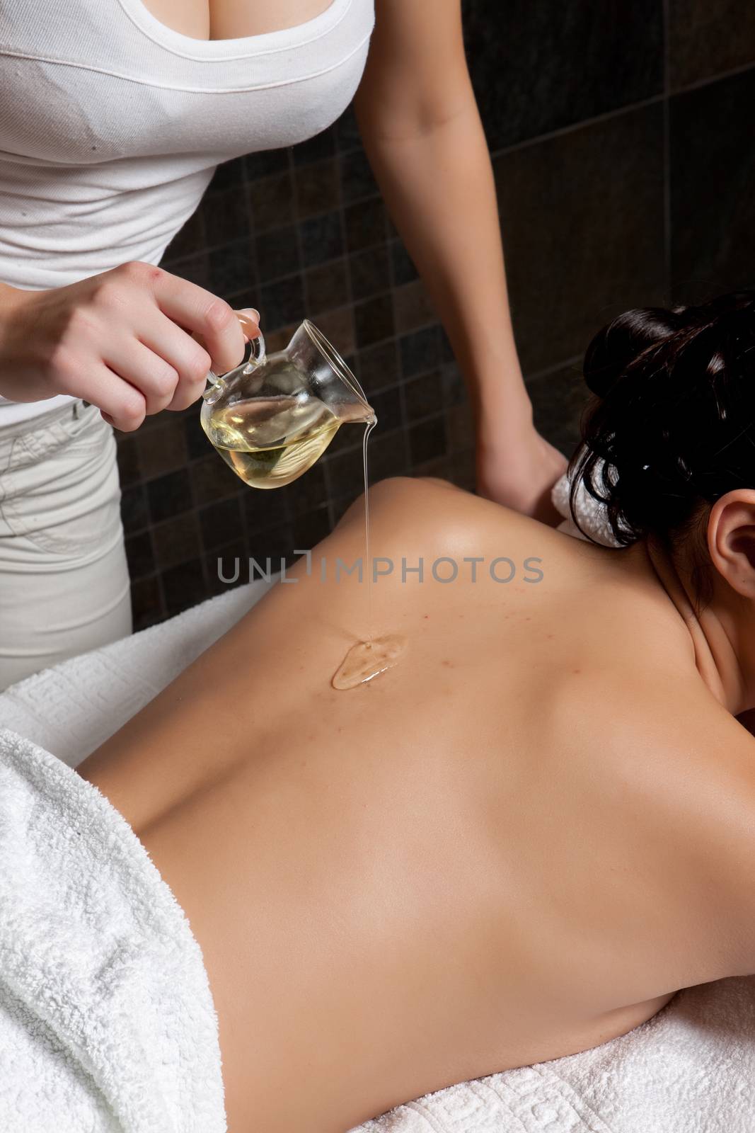 Young attractive woman taking massage and spa procedures