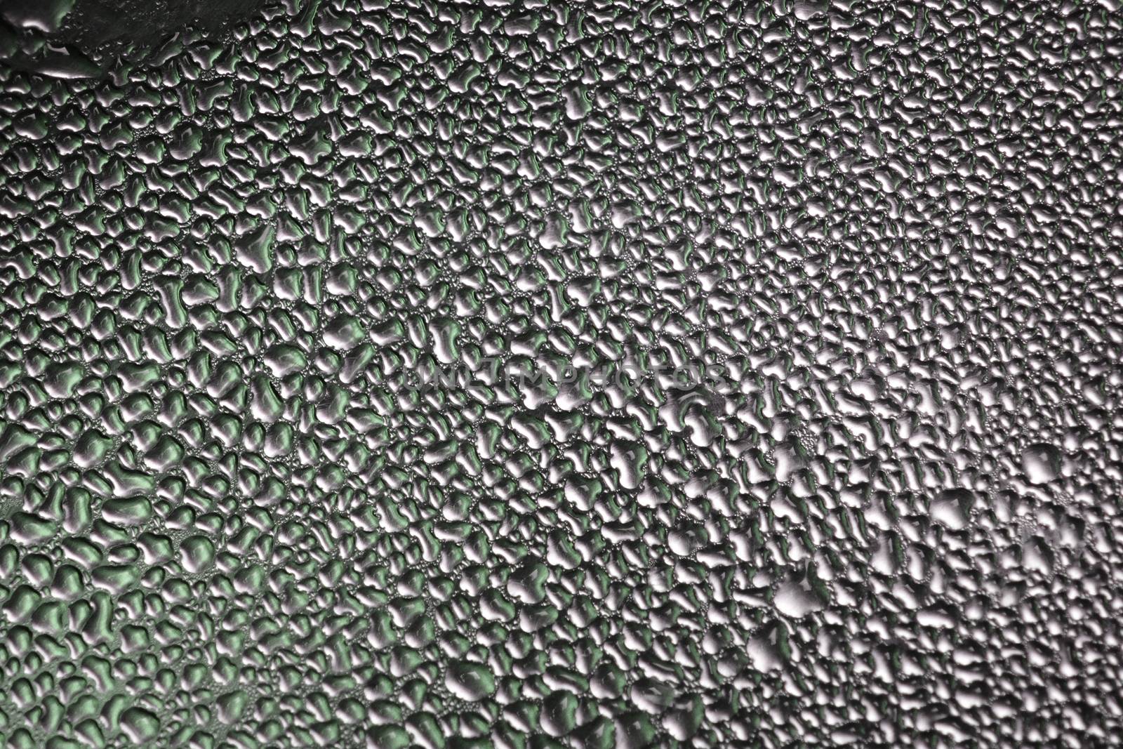 Deail of metal surface covered in water drops - abstract background