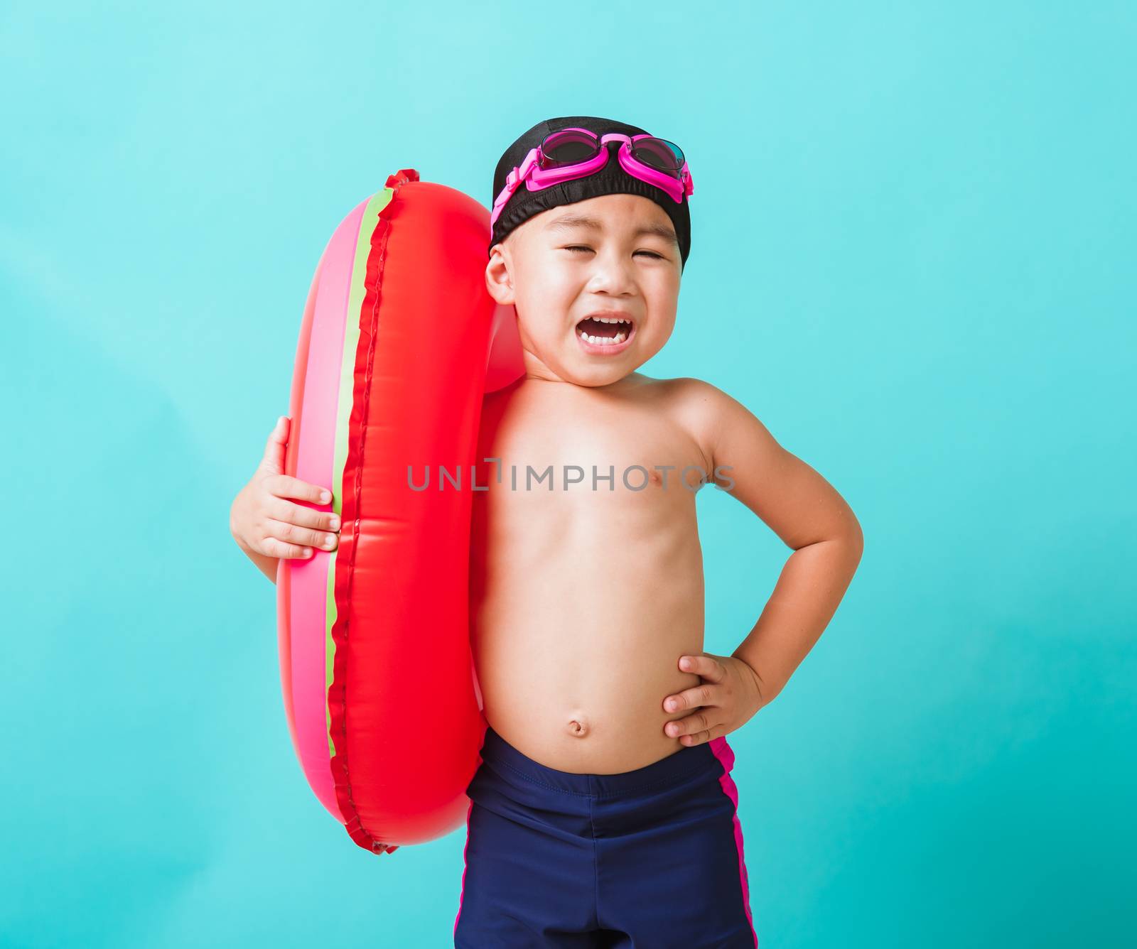 Child boy wearing goggles and swimsuit holding beach watermelon  by Sorapop