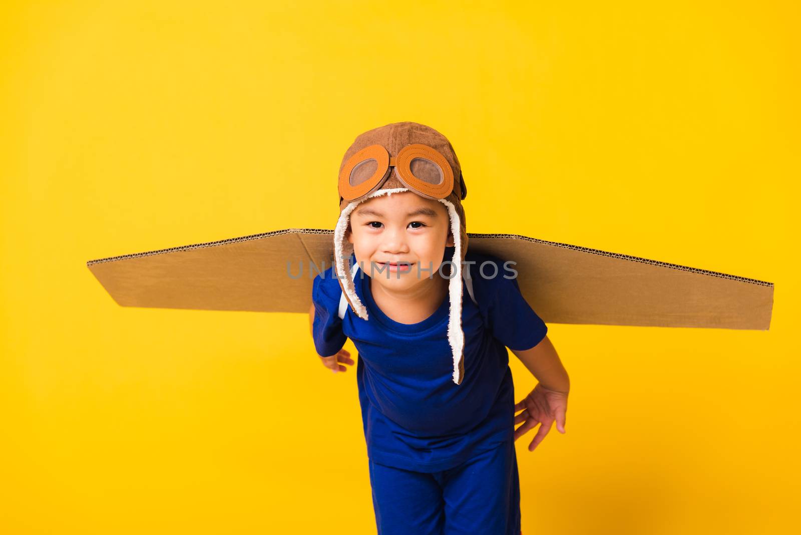 Kid little boy smile wear pilot hat play and goggles with toy ca by Sorapop