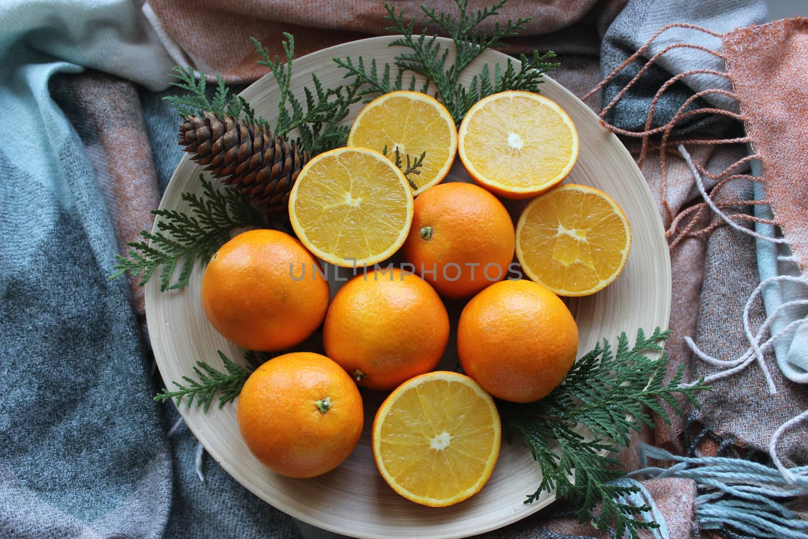 Lots of oranges and slices on a white plate.Texture or background