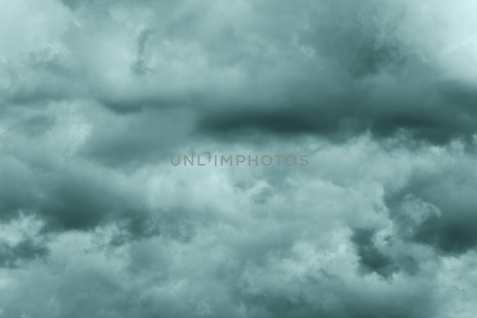 Dramatic storm clouds in rainy weather in sky, coloring in trend Tidewater Green color of year 2021. Meteorology abstract texture, nature background. Toned image, soft focus and motion blur cloudscape