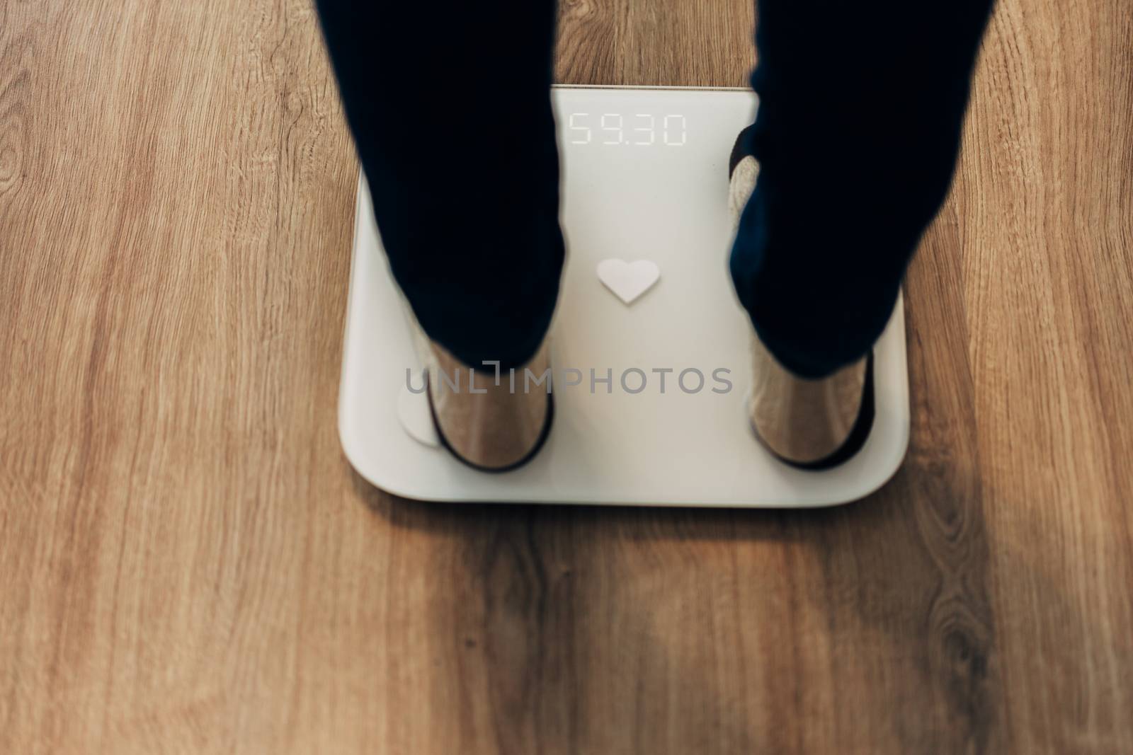 Girl Measures Weight on Smart Scales. Modern Electronic Device. by TrEKone