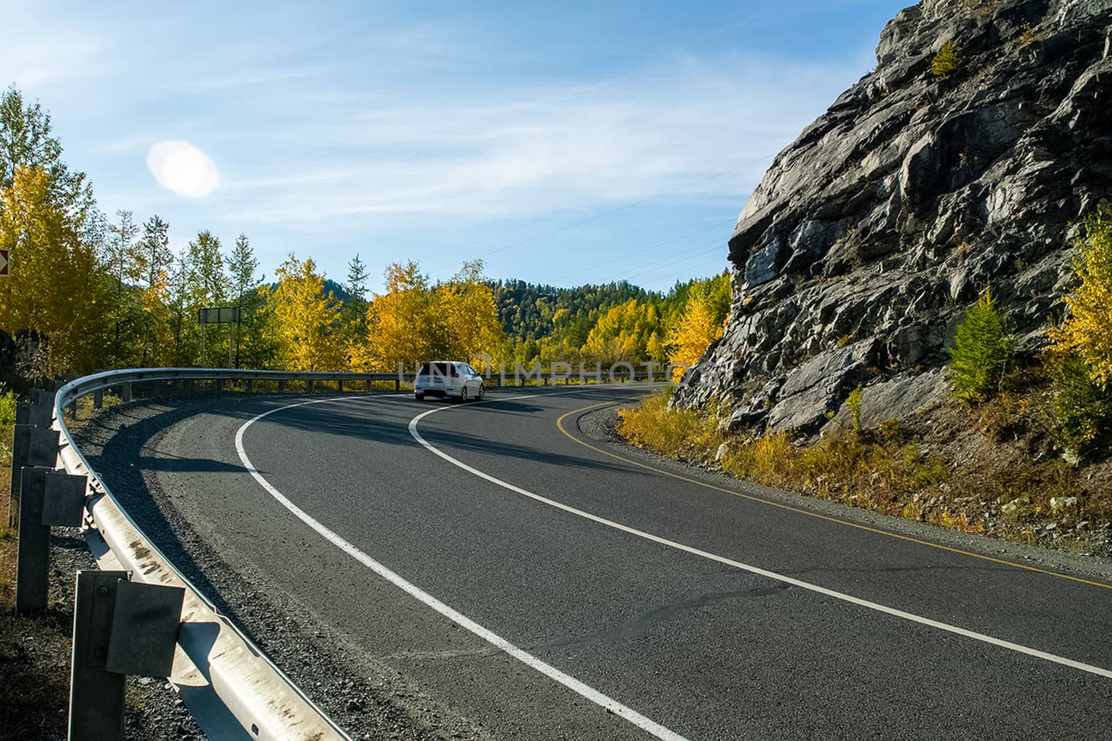 Asphalt road to the mountains. Mountain track on the Altai.