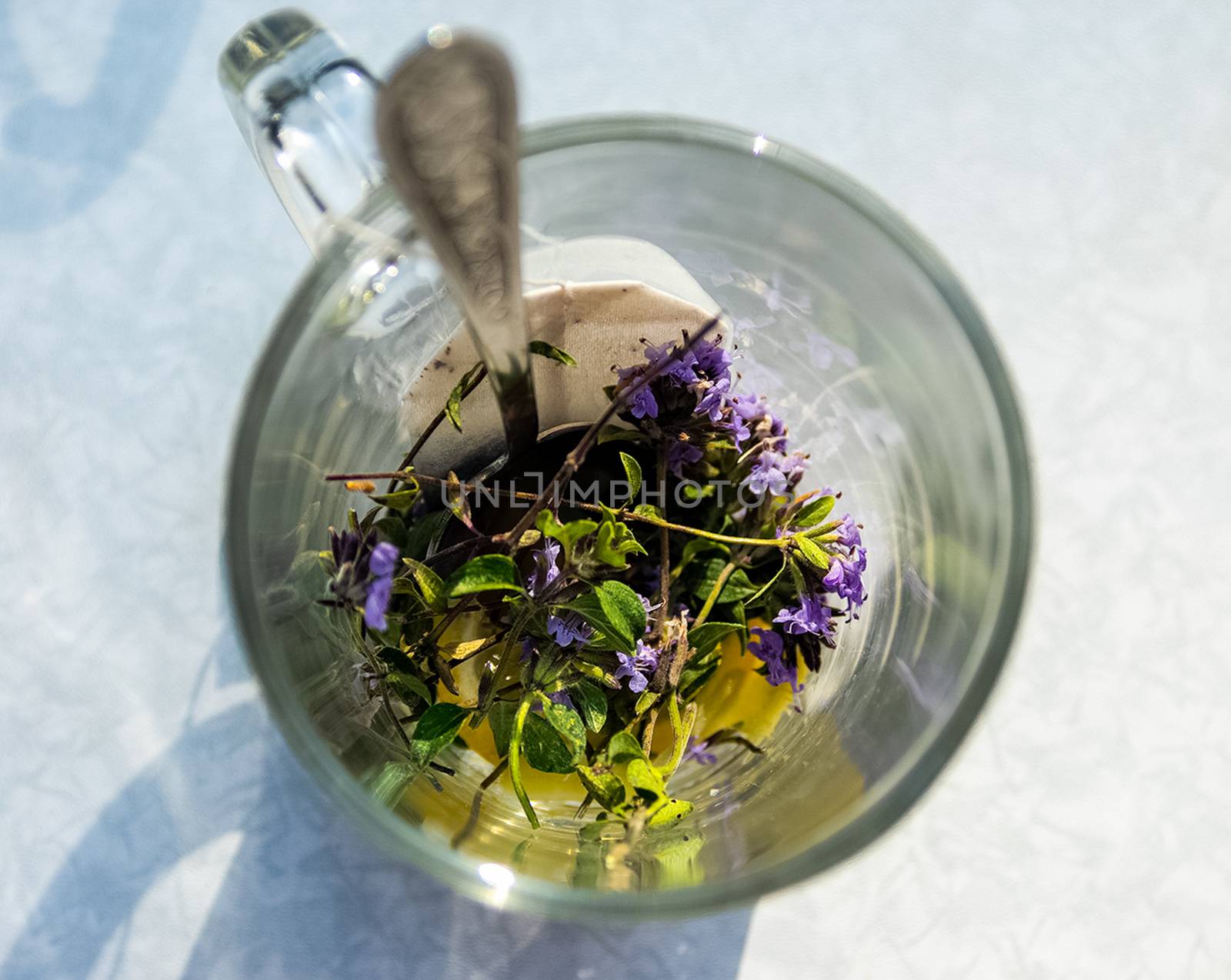Transparent mug with tea. Brewing tea in a bag. Brewing herbal tea. Herbal tea.