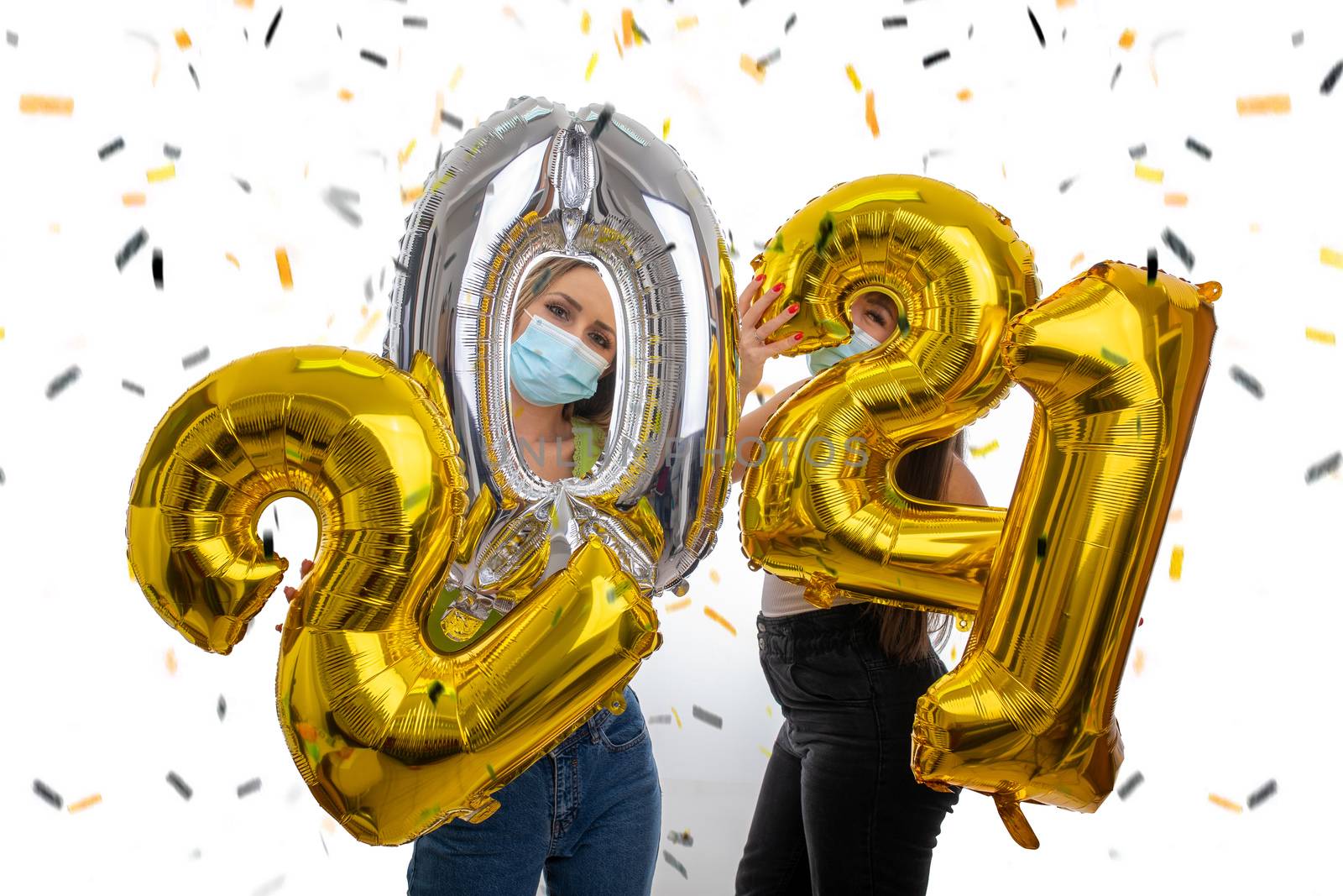 Happy friends celebrate the New Year 2021 with face masks