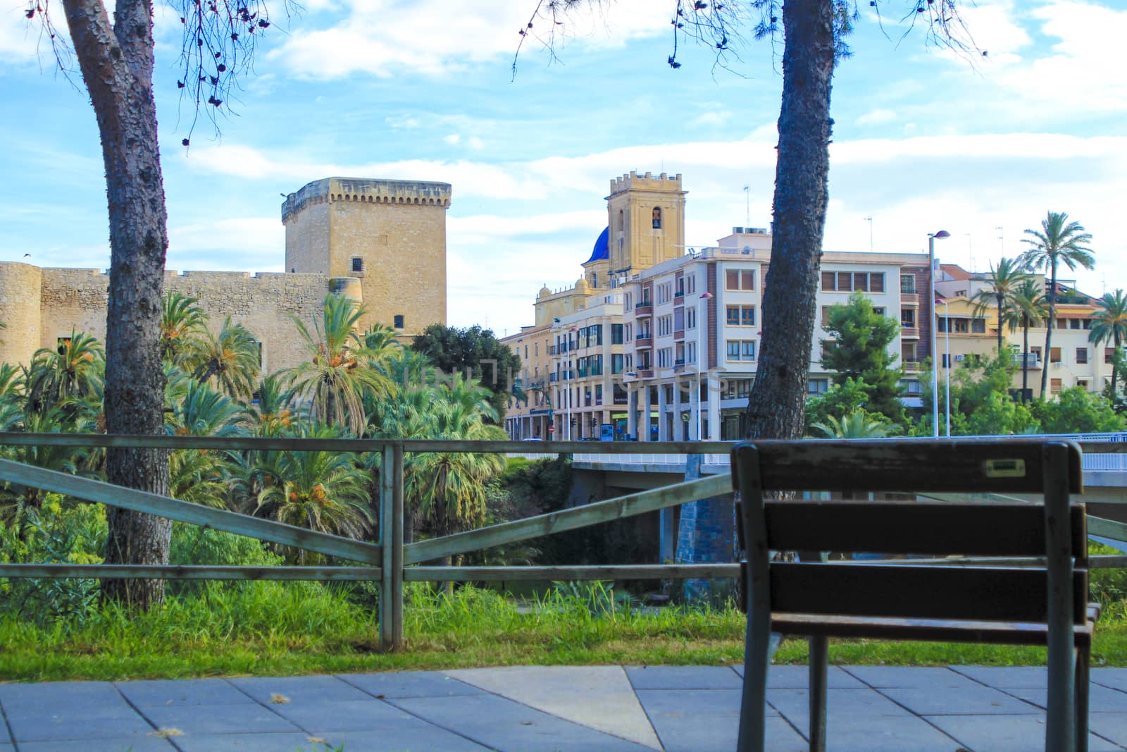 Elche, Alicante, Spain- November 16, 2020 - Landscape of the hillside of the Vinalopo River in Elche. Altamira Palace, Altamira bridge and Santa Maria church in the background