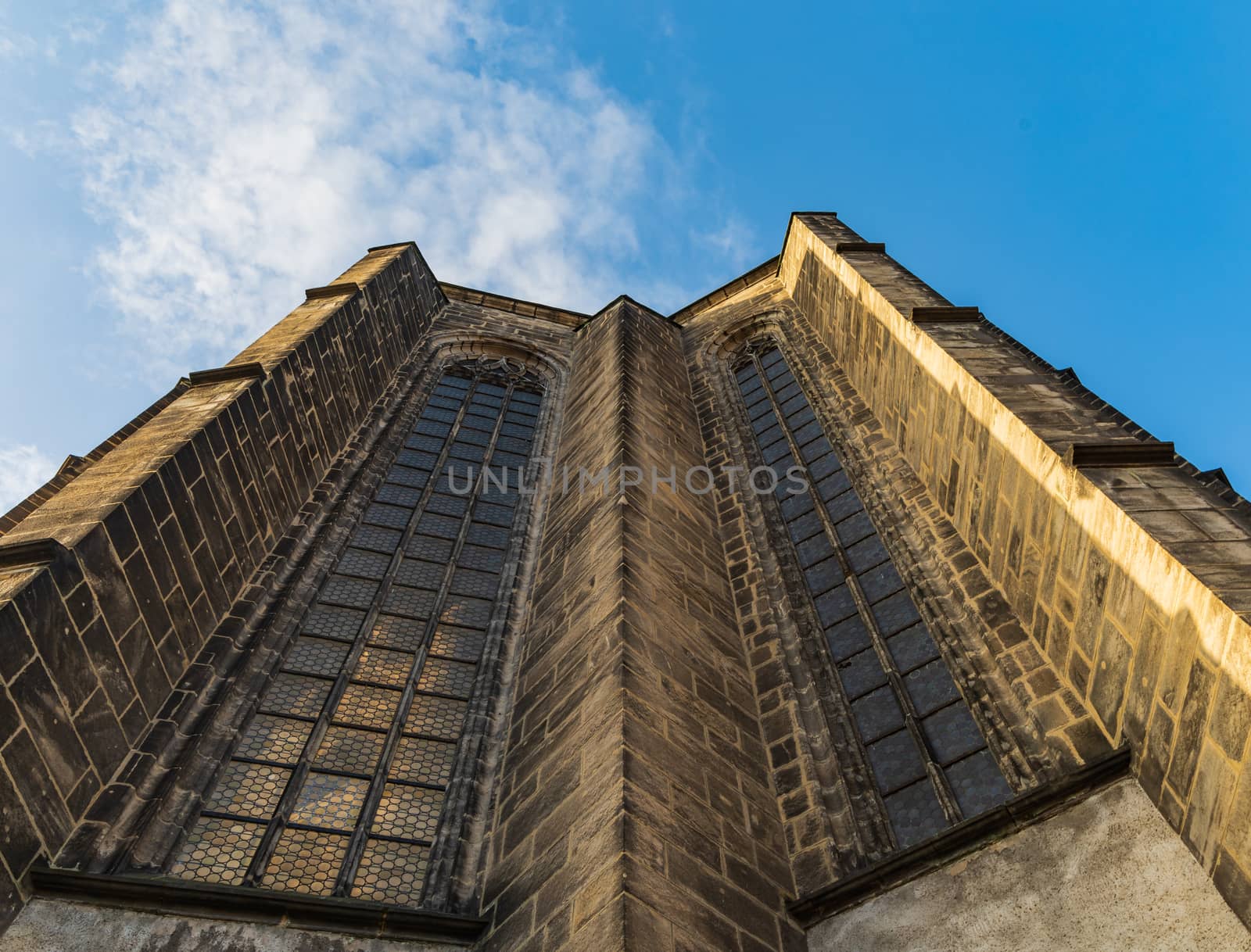 Upward view to wall of big cathedral with huge windows by Wierzchu