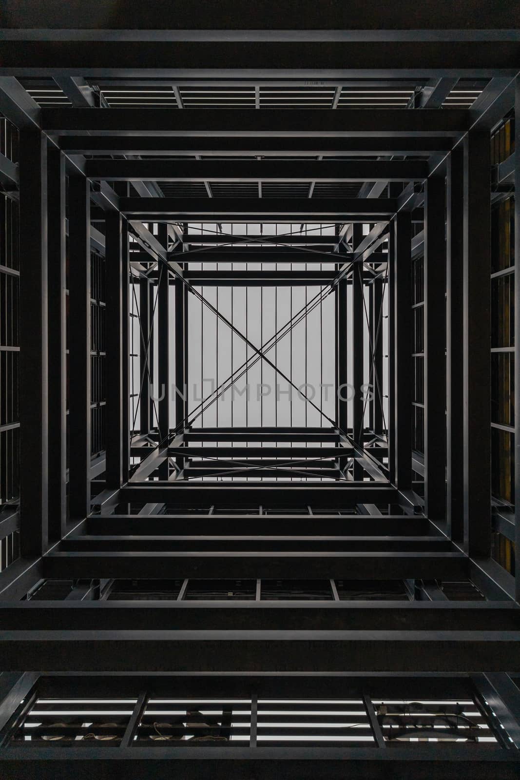 Upward view inside metal tower construction 