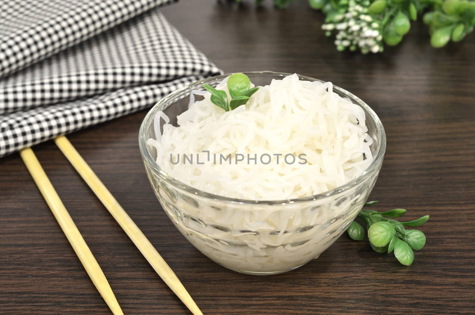 Konjac or Shirataki noodles with Chinese chopsticks. Japanese traditional dish. Healthy food for weight loss, keto diet concept.