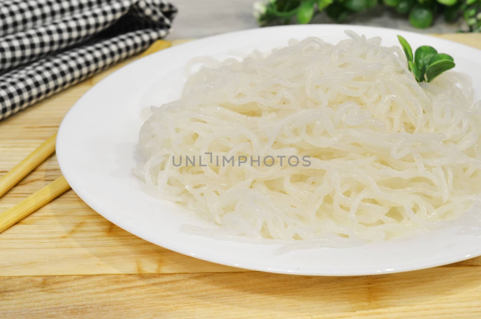 Konjac or Shirataki noodles with Chinese chopsticks. Japanese traditional dish. Healthy food for weight loss, keto diet concept by lucia_fox