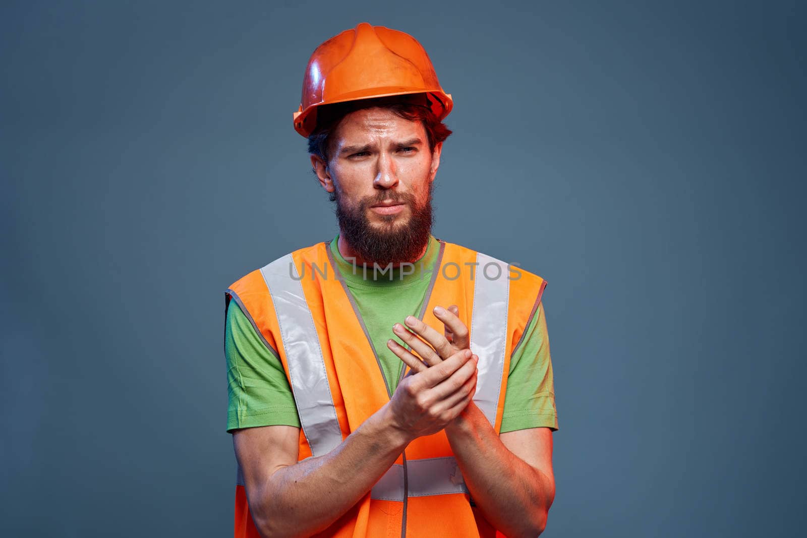 Man in working uniform to professionals construction lifestyle blue background. High quality photo