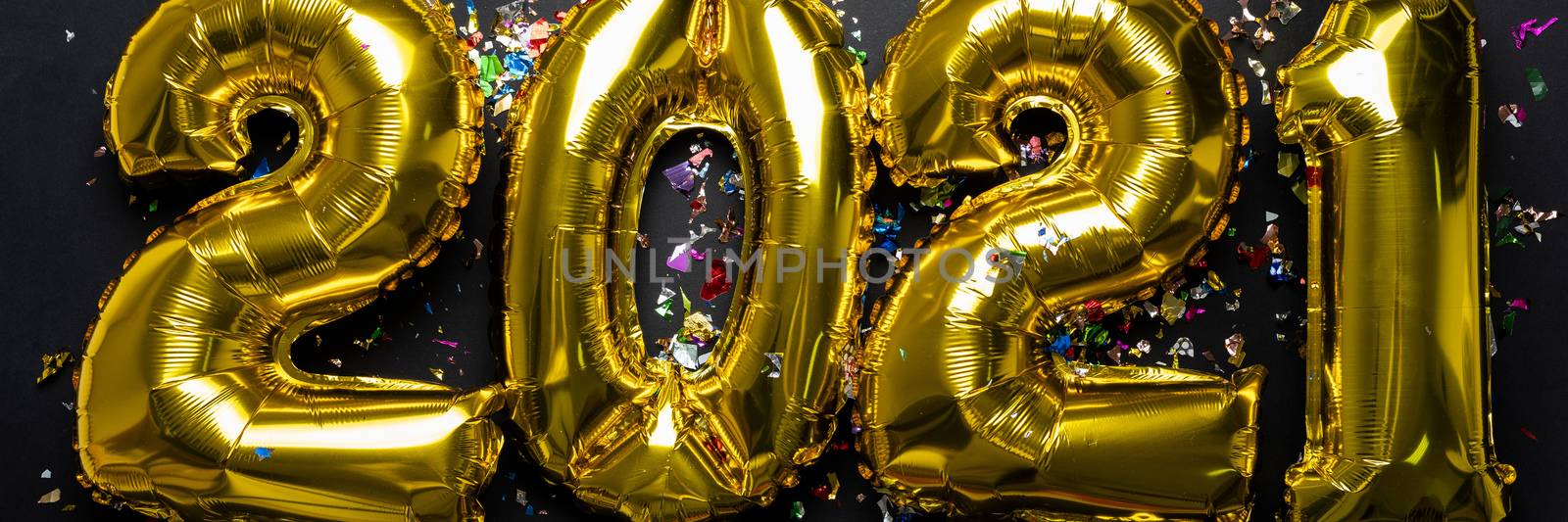 2021 new year numbers from golden foil balloon and confetti by adamr