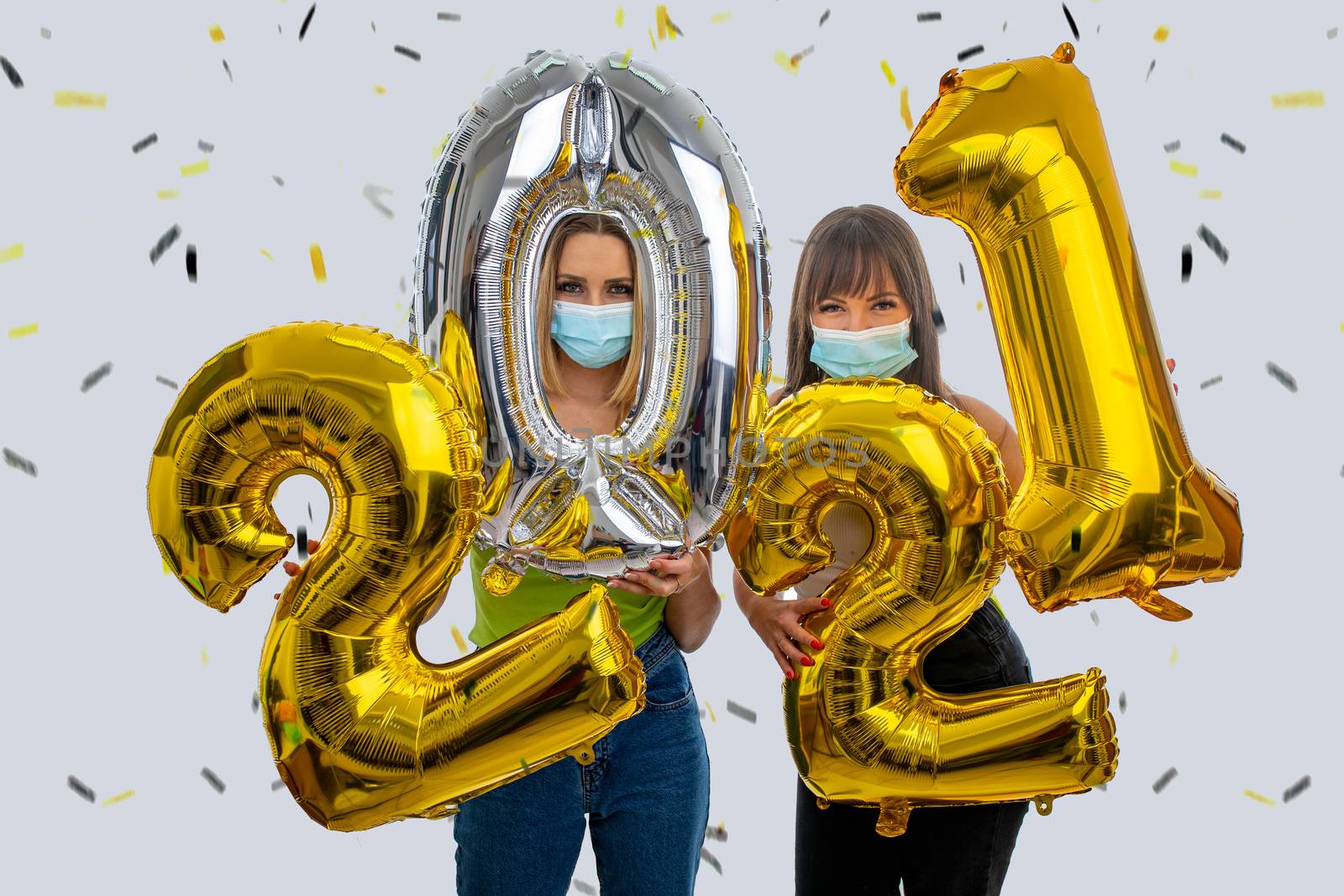 Happy friends celebrate the New Year 2021 with face masks