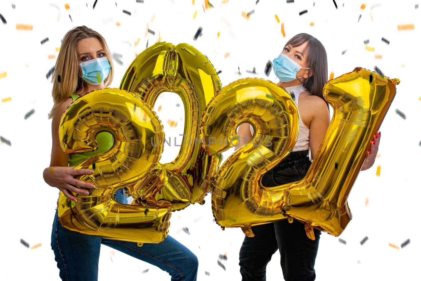 Happy friends celebrate the New Year 2021 with face masks