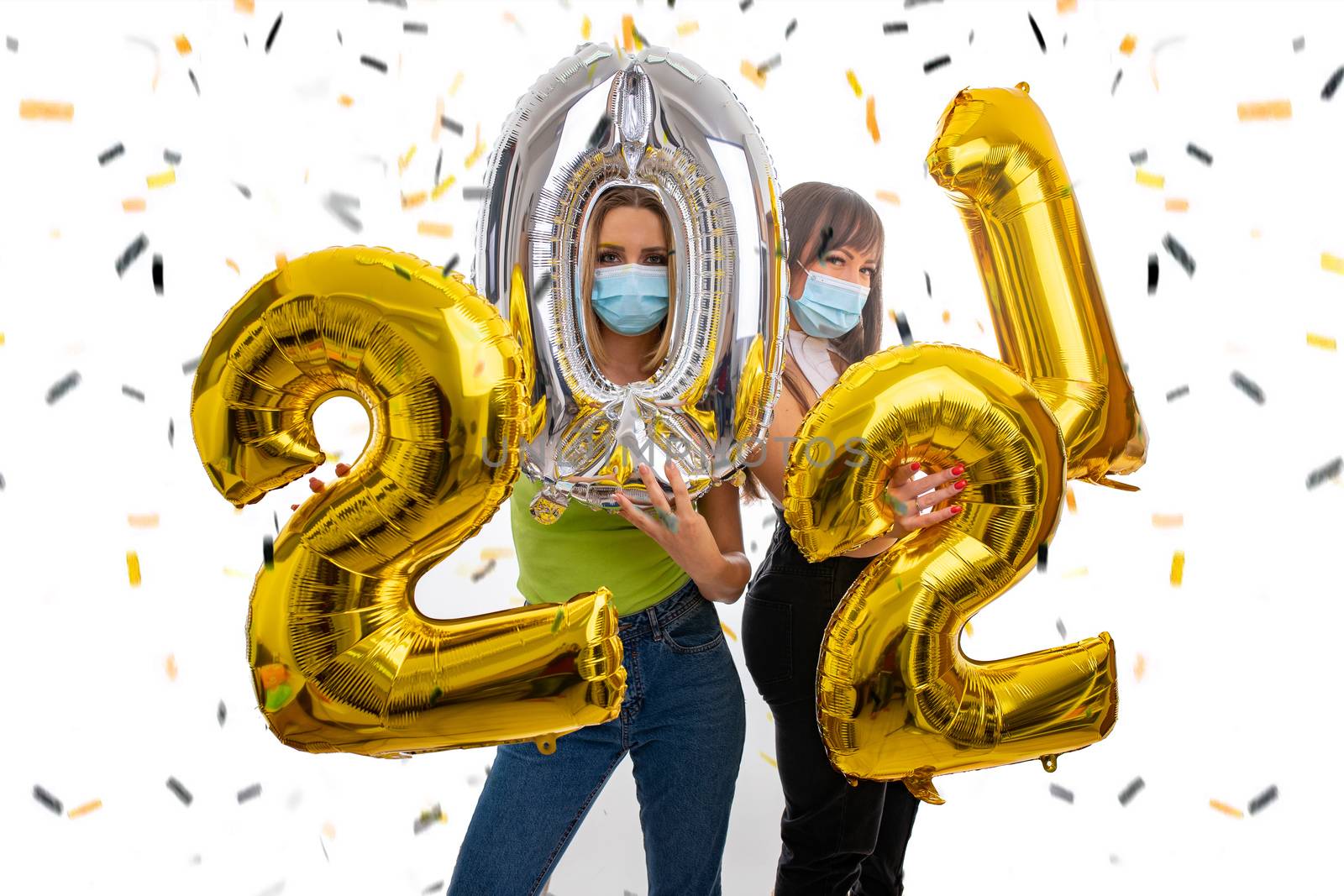 Happy girls celebrate the New Year 2021 with face masks by adamr