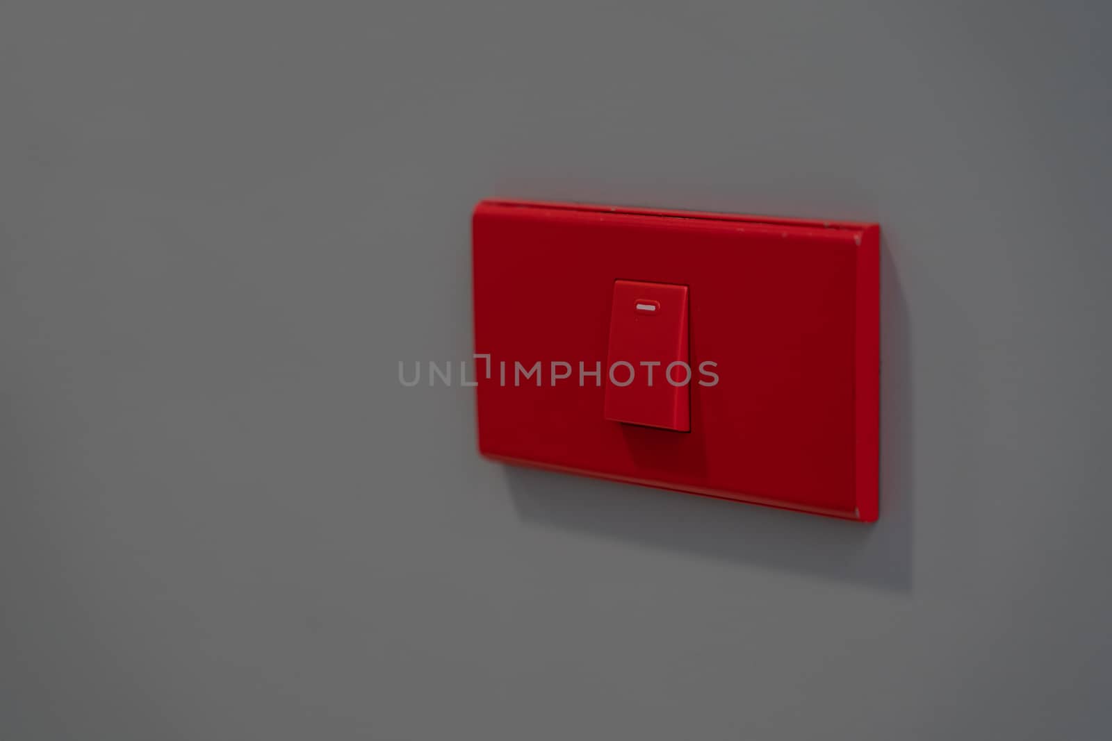 Electric button switch, electric control on-off on grey background.