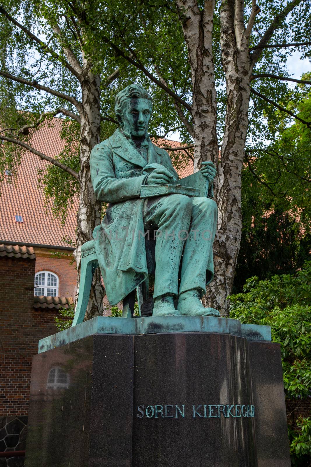 Copenhagen, Denmark - August 22, 2019: Statue of famous Danish philosopher Soren Kierkegaard by artist Louis Hasselriis in the Royal Library Garden.