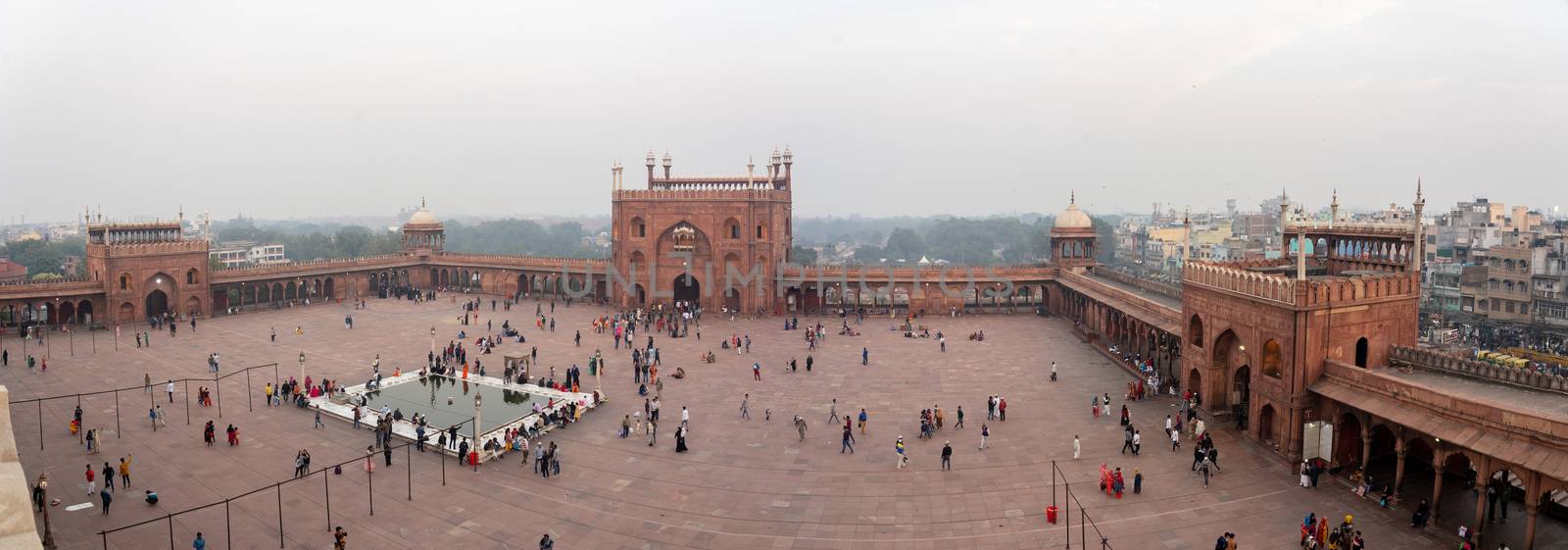 Delhi, India - December 04, 2019: The three entrance gates to Jama Masjid with people on the square.