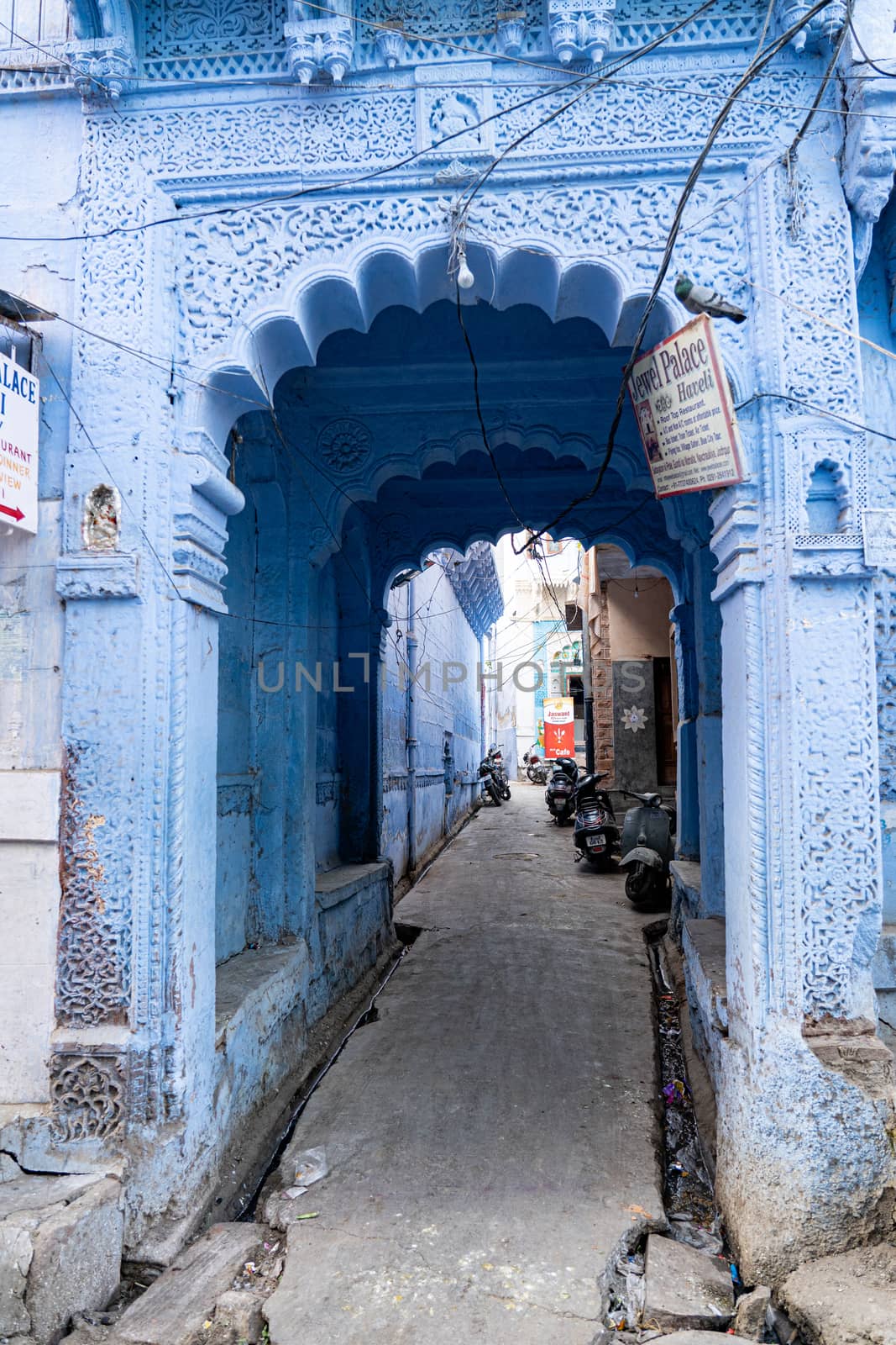 Jodhpur, India - December 9, 2019: An old door to a traditional blue house.