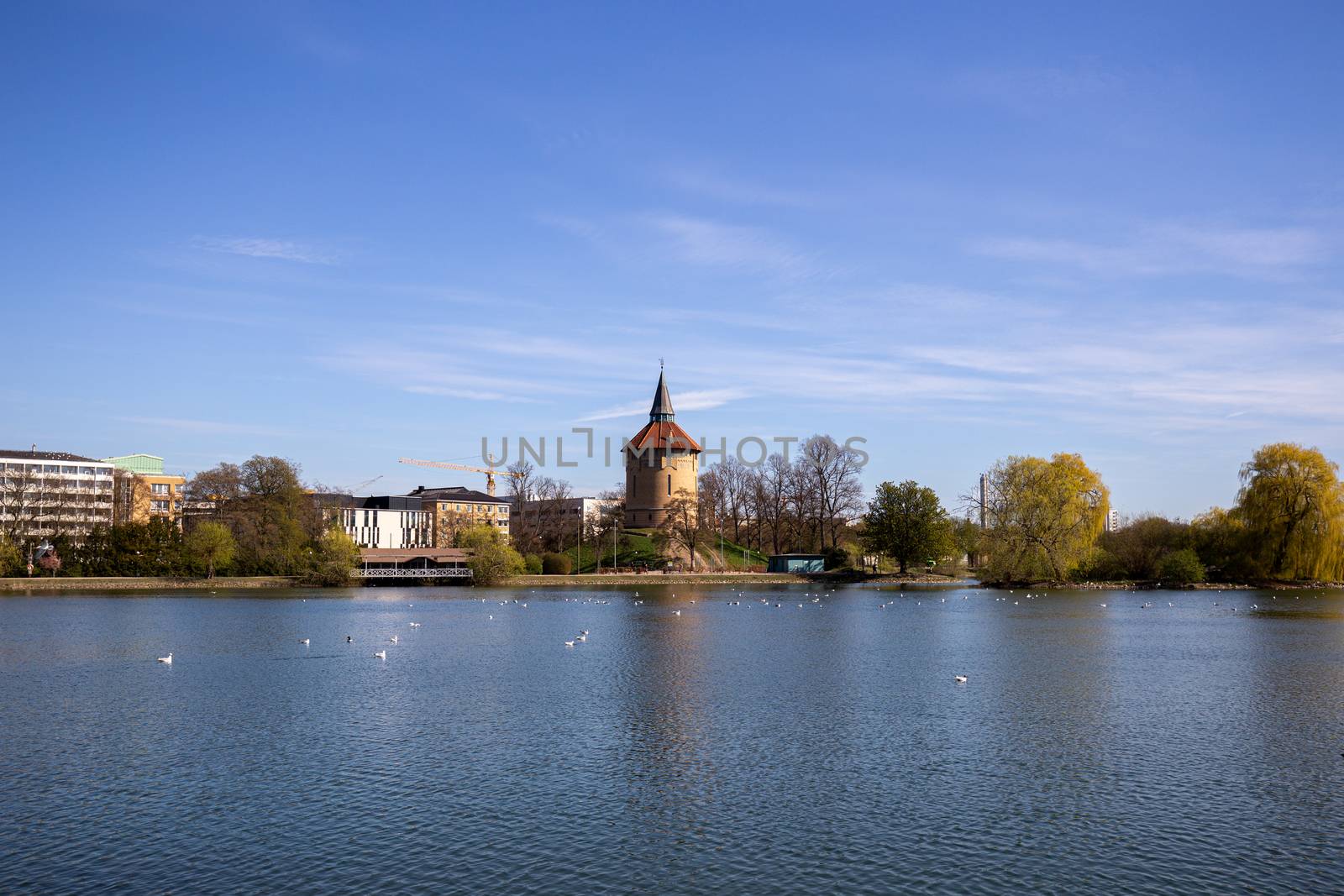 Malmo, Sweden - April 20, 2019: View over the lake in Pildammsparken with the former water tower.