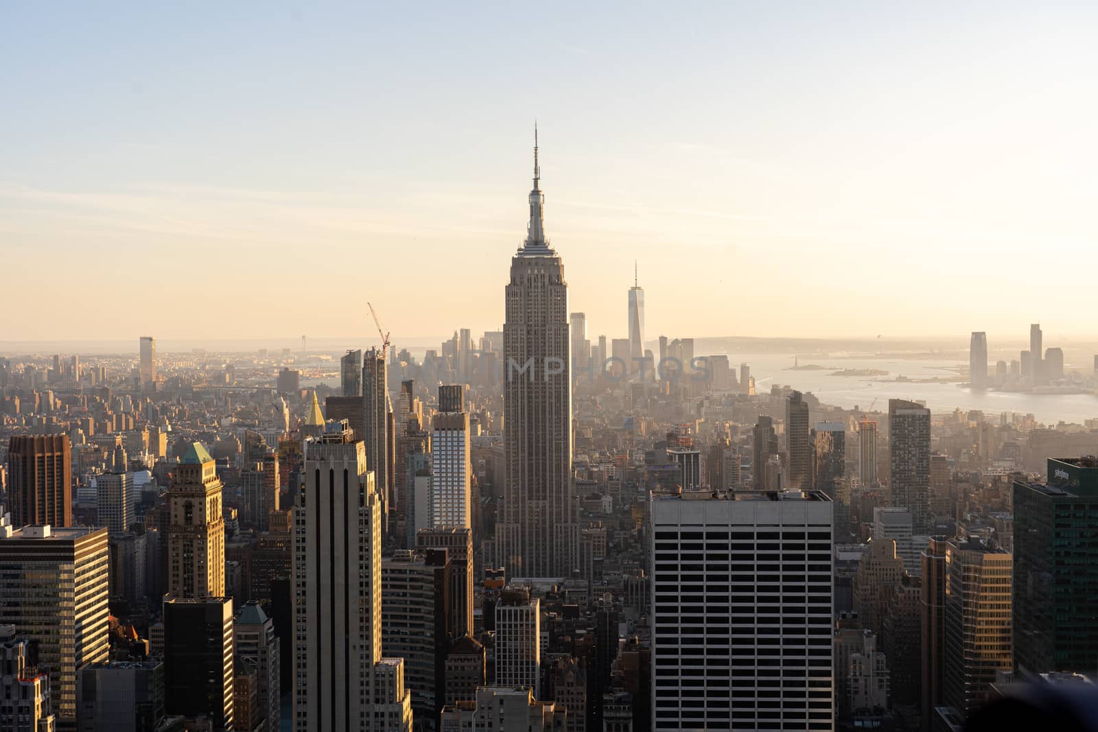 NYC, USA - September 21, 2019: NYC skyline with the Empire State Building in the foreground seen from top of the Rockefeller Center