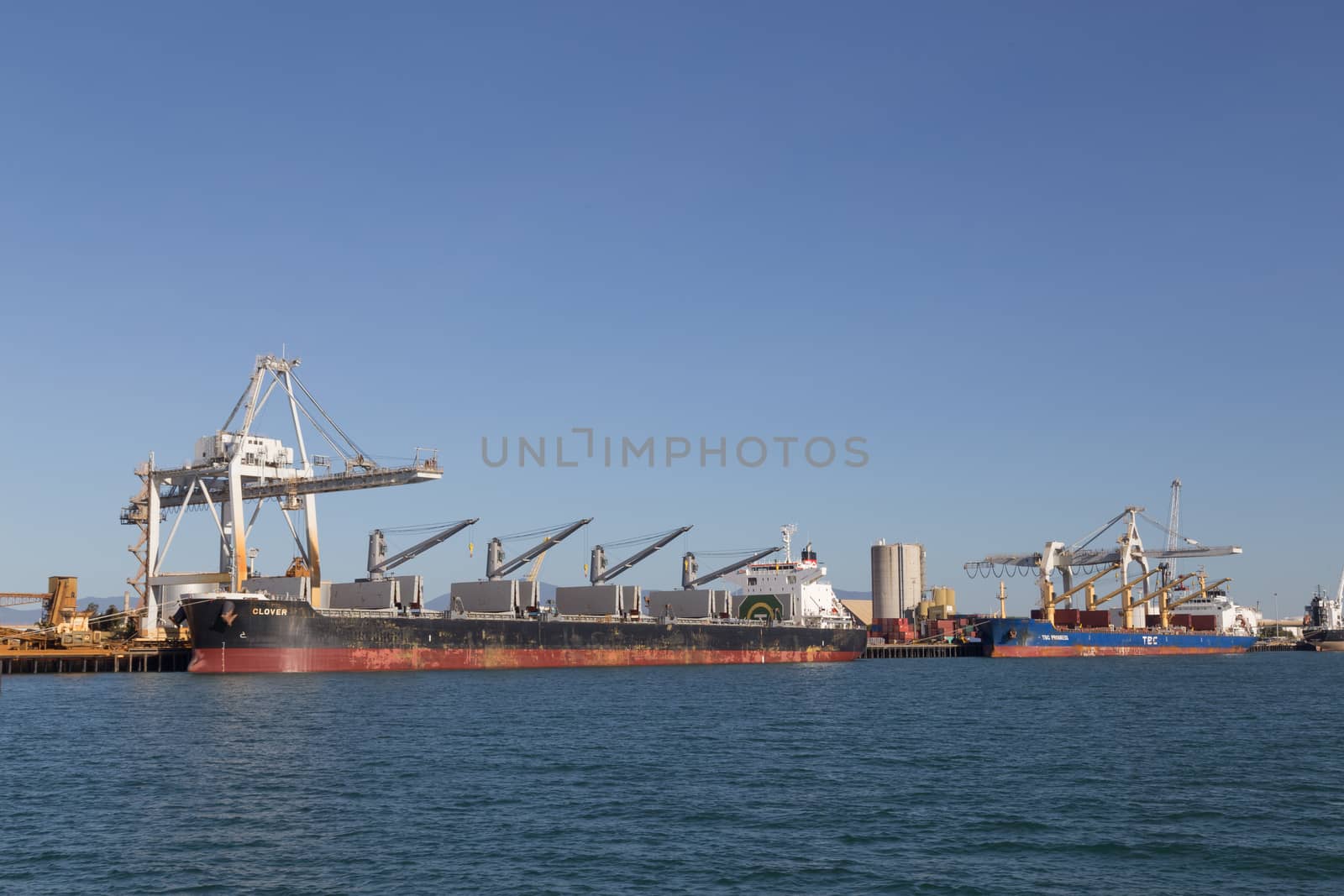 Townsville, Australia - May 11, 2015: Cargo ships are being unloaded at container terminal.