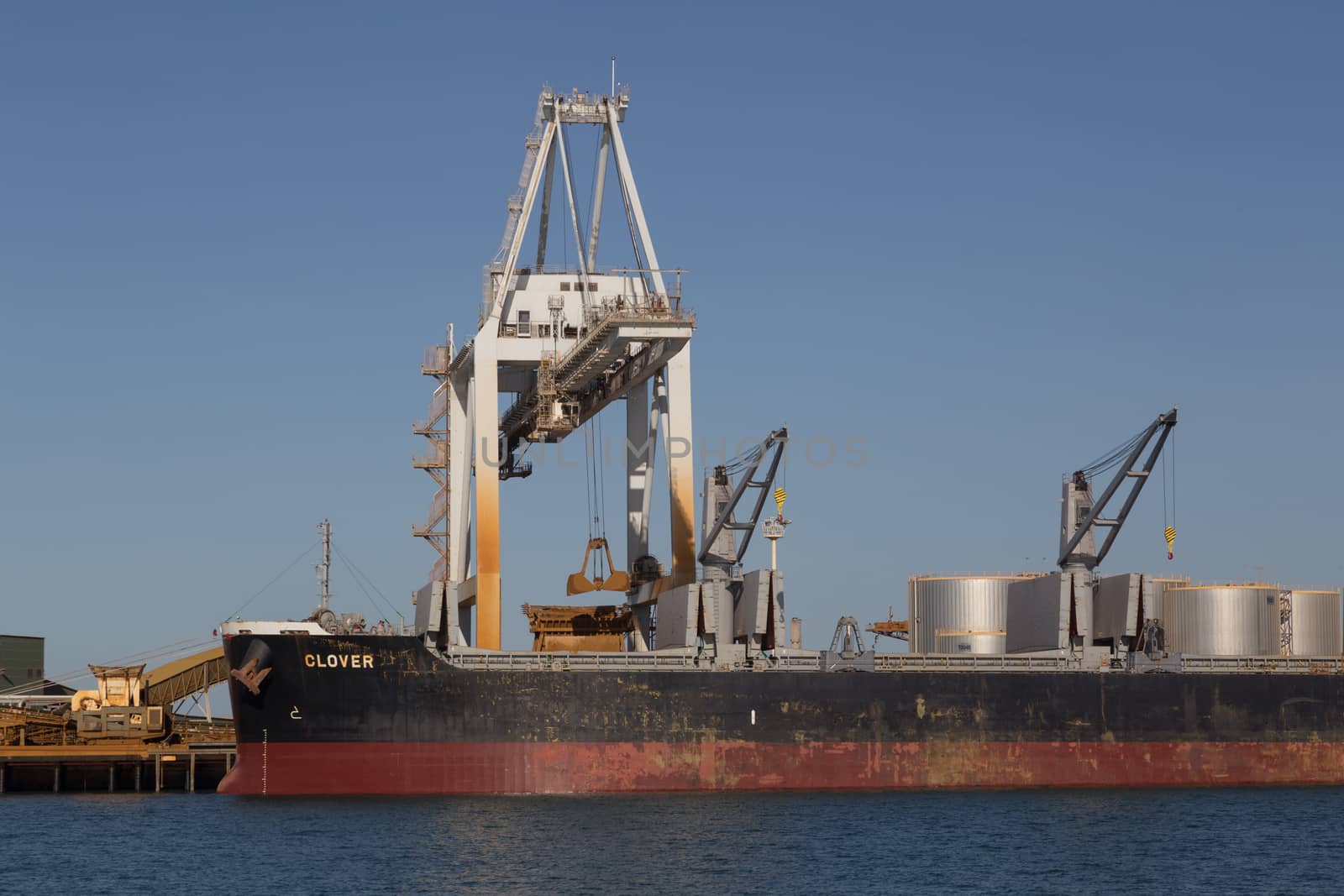 Townsville, Australia - May 11, 2015: Cargo ship is being unloaded at container terminal.