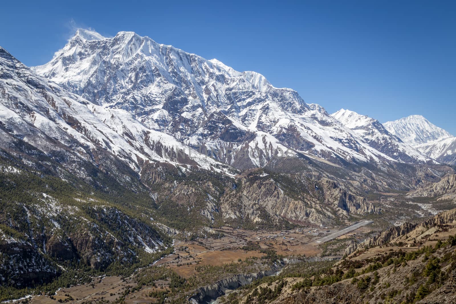 Manang, Nepal - October 28, 2014: View of a valley with the village Manang and the airport in the Annanpurna Conservation Area.