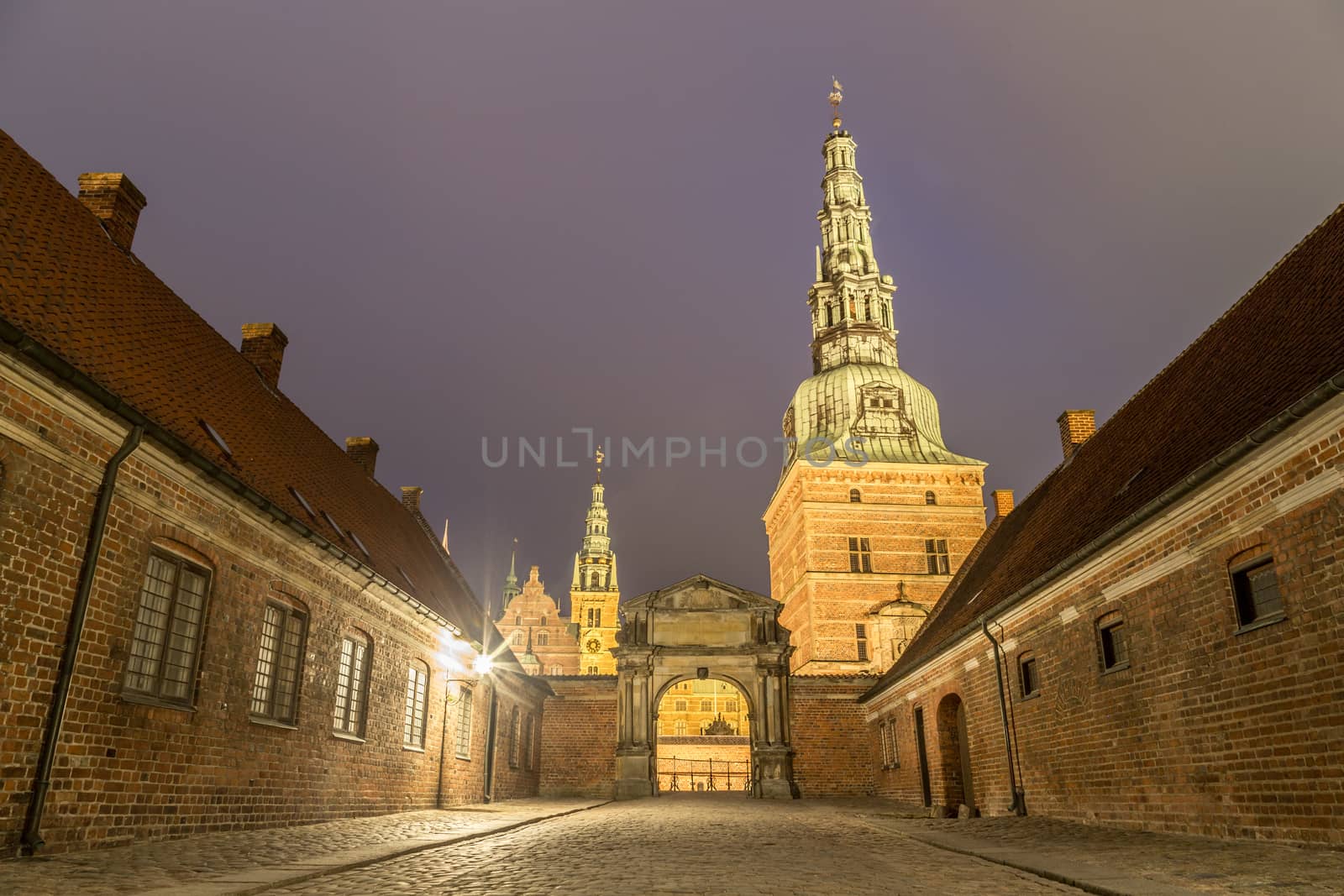 Hillerod, Denmark - December 29, 2016: View of the illuminated entrance gate to Frederiksborg Palace