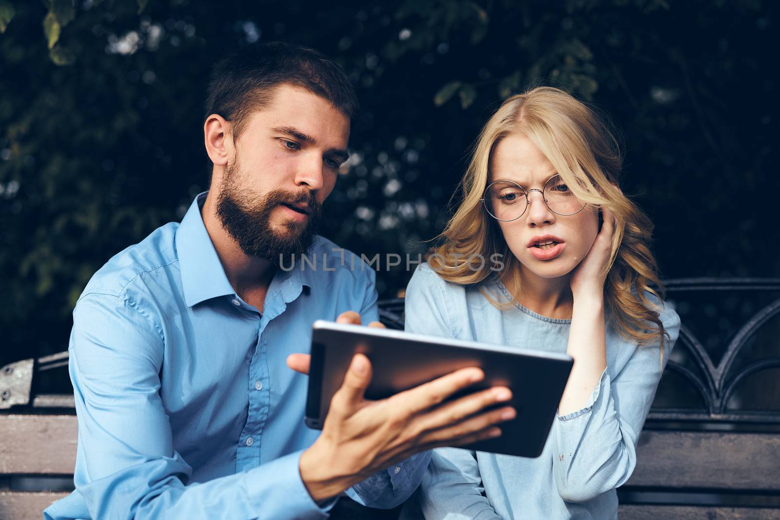 business man and woman sitting on bench communication technology work colleagues meeting. High quality photo