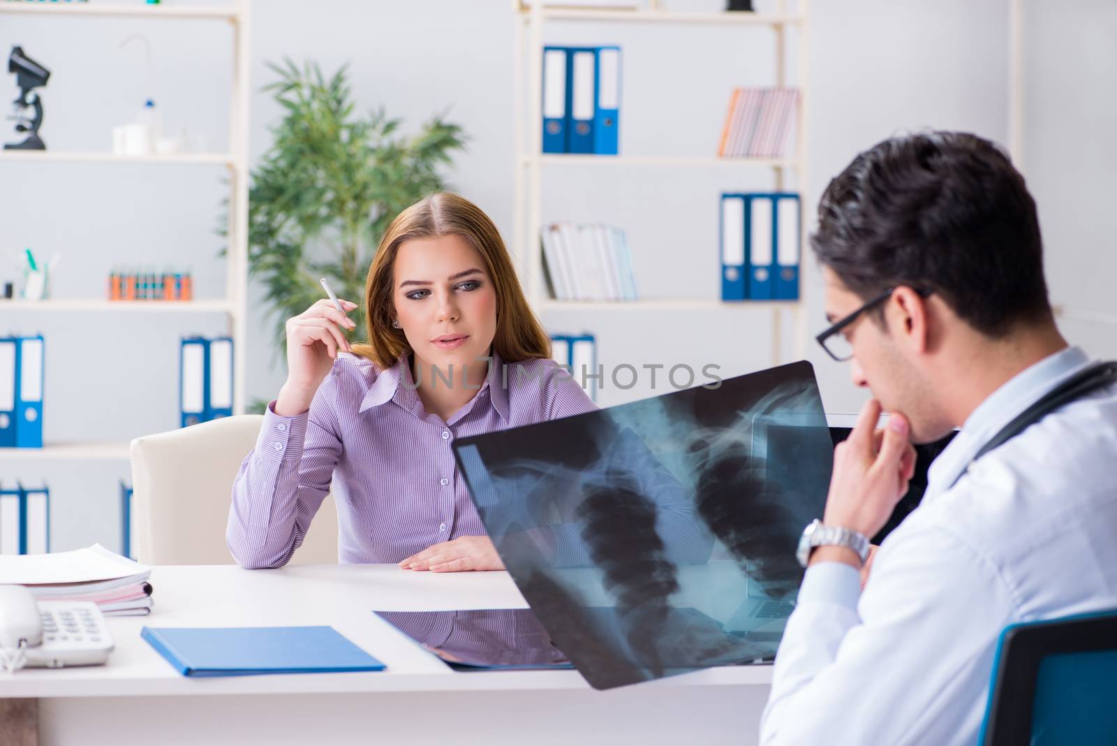 Doctor examining x-ray images of patient by Elnur