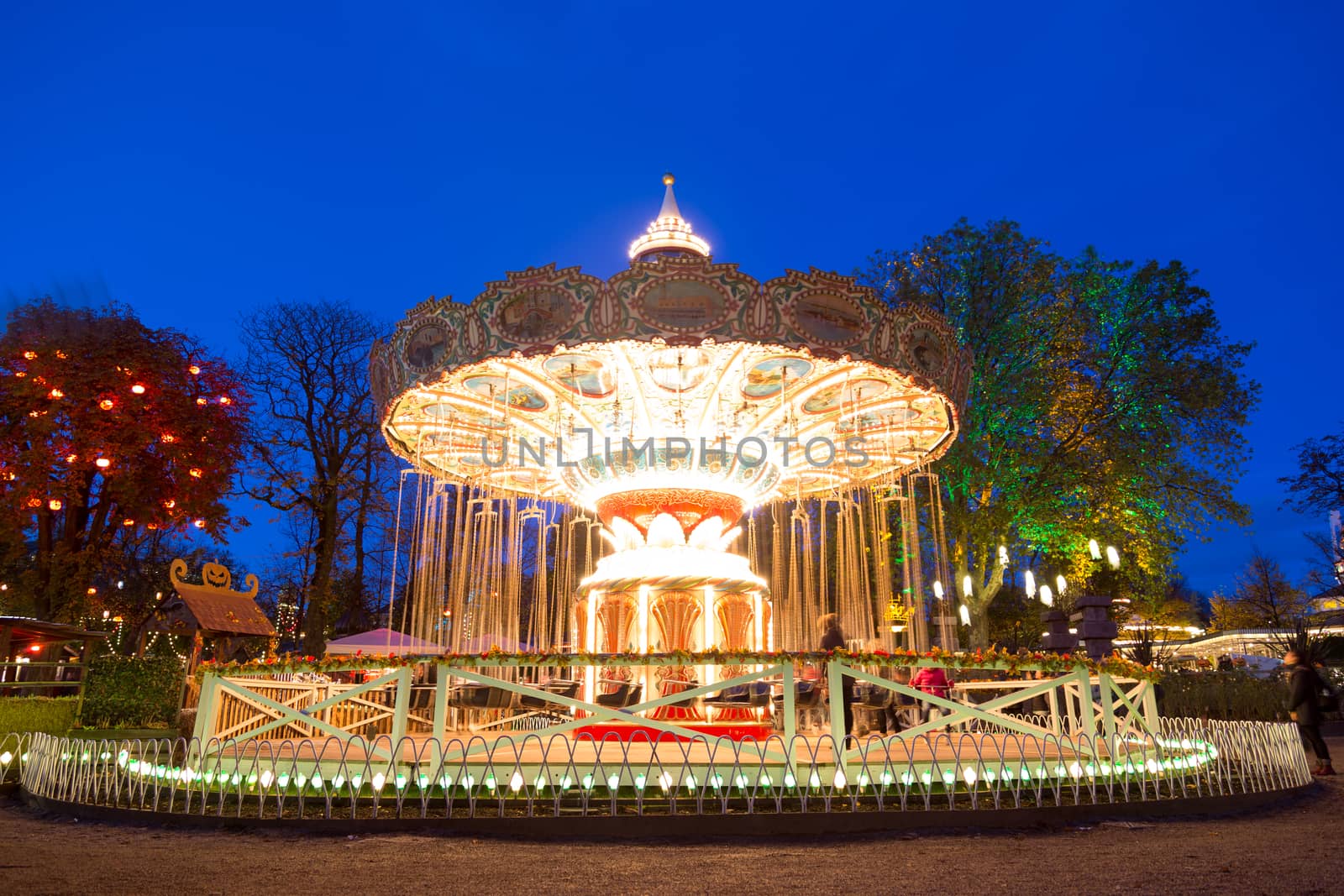 Copenhagen, Denmark -  October 26, 2017: An illuminated carousel in an amusement park at night