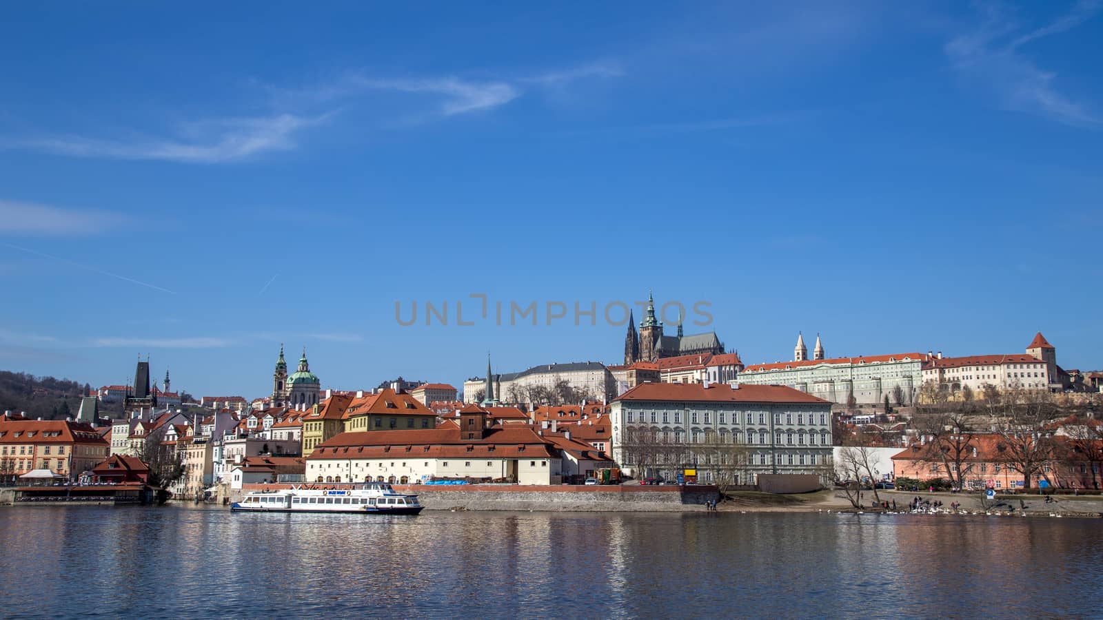 Prague, Czech Republic - March 16, 2017: Vlata River Water front with Prague Castle in the background