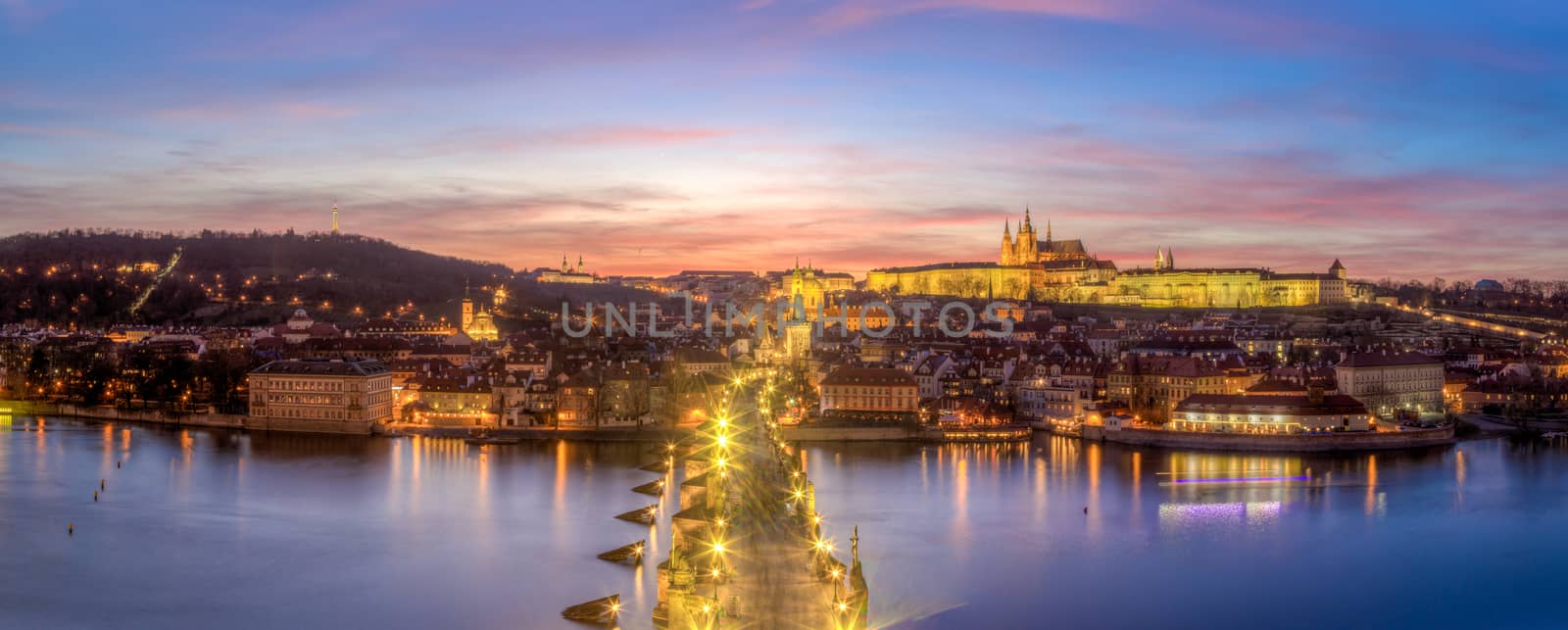 Prague, Czech Republic - March 16, 2017: Evening panorama of Prague Castle and Charles Bridge from the Old Town Bridge Tower