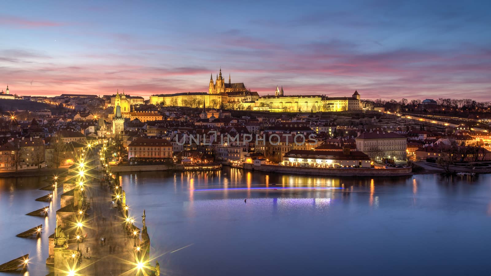 Prague, Czech Republic - March 16, 2017: Evening view of Prague Castle and Charles Bridge from the Old Town Bridge Tower