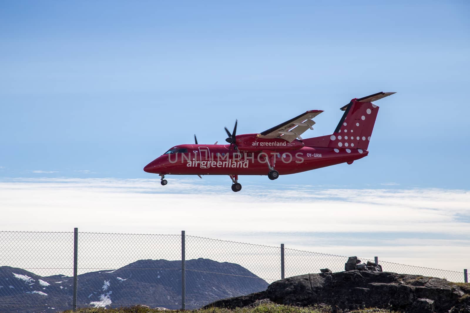 Ilulissat, Greenland - June 30, 2018: A Bombardier Dash 8 Q200 aircraft operated by Air Greenland landing at the airport