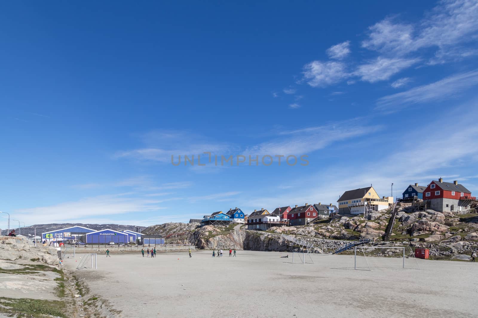 Ilulissat, Greenland - June 30, 2018: People playing soccer on the soccer field