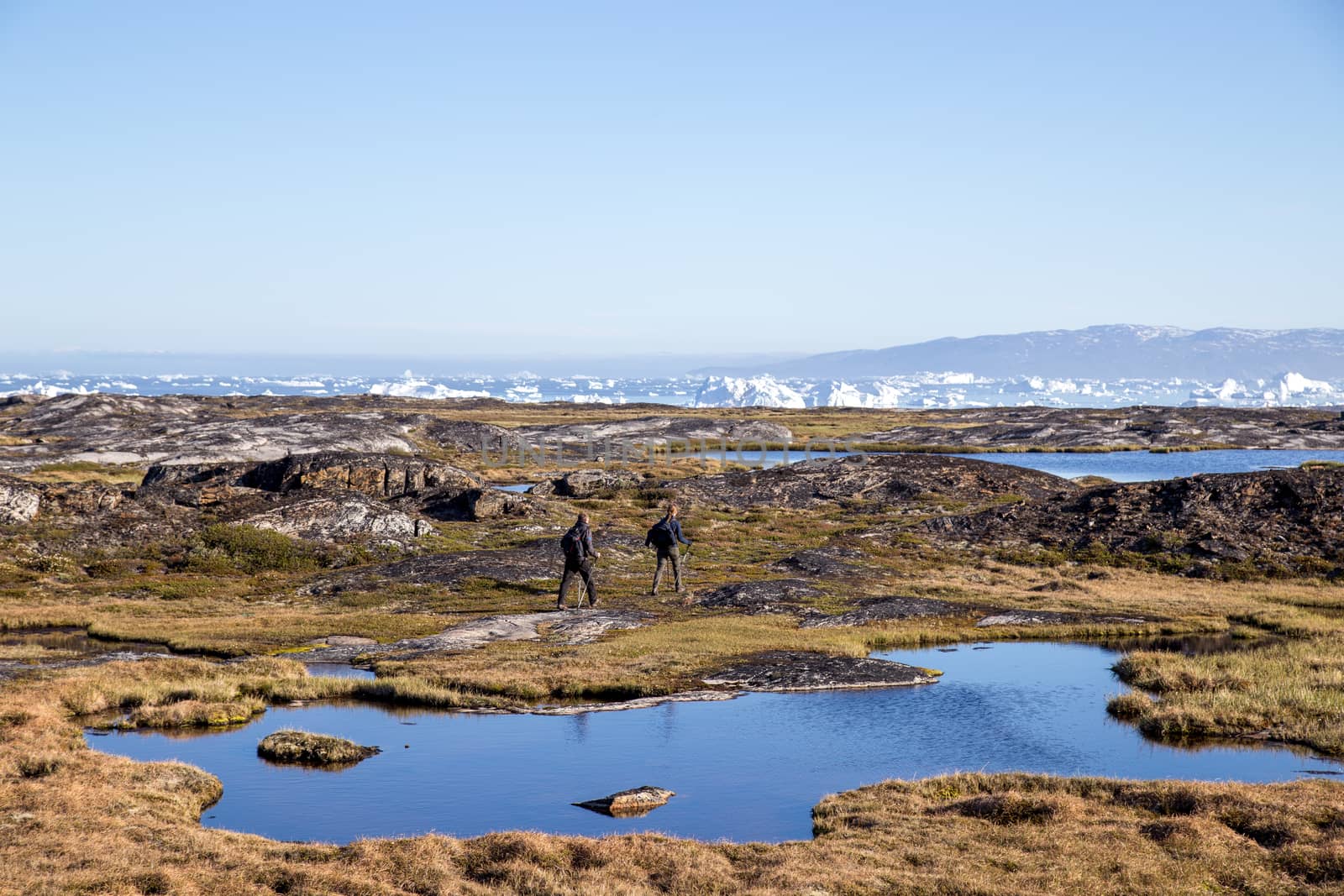 People hiking close to Ilulissat, Greenland by oliverfoerstner