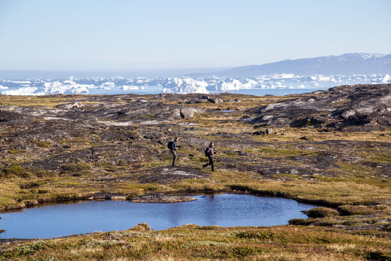 People hiking close to Ilulissat, Greenland by oliverfoerstner