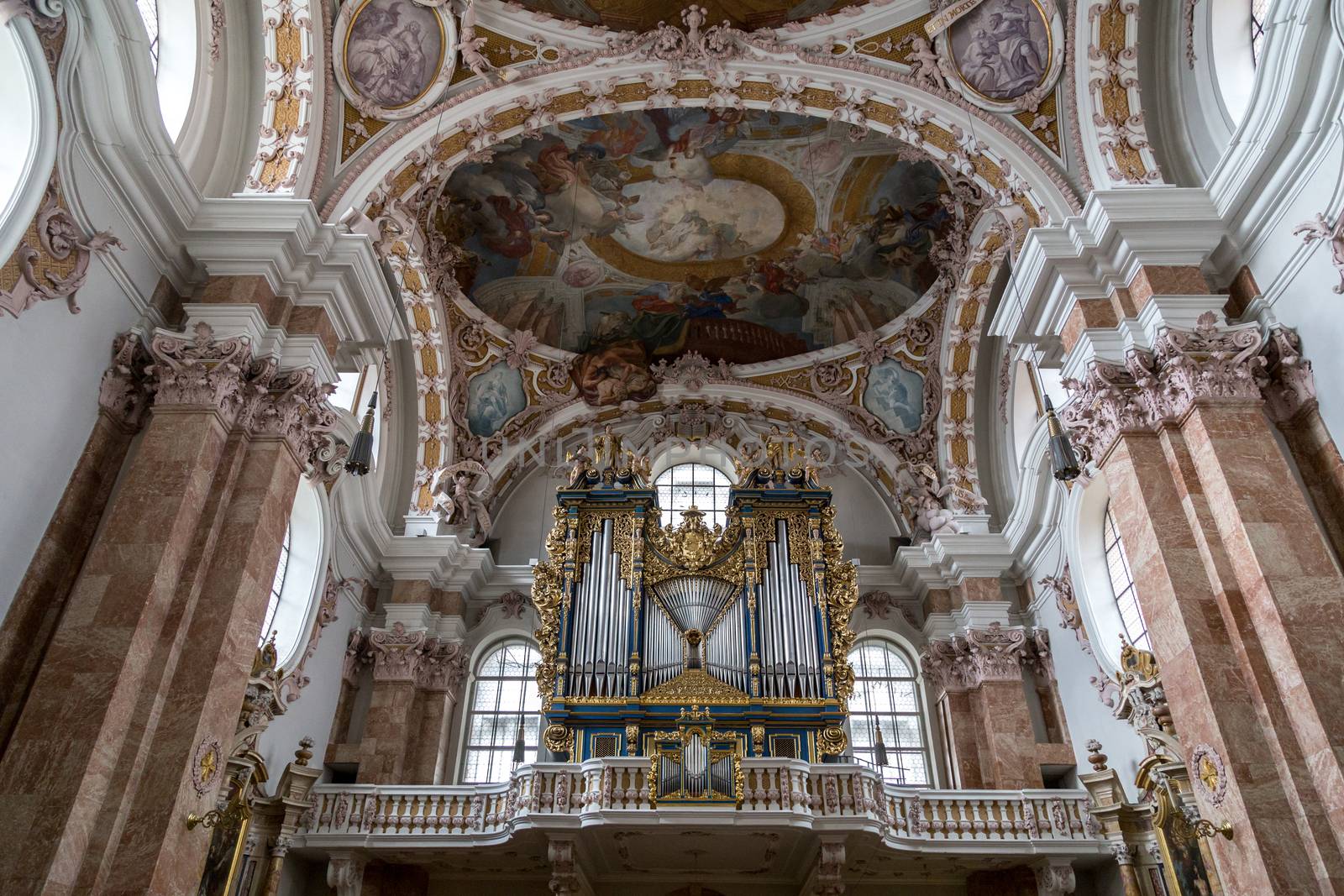 Innsbruck, Austria - June 8, 2018: Pipe organ and ceiling painting inside Innsbruck Cathedral