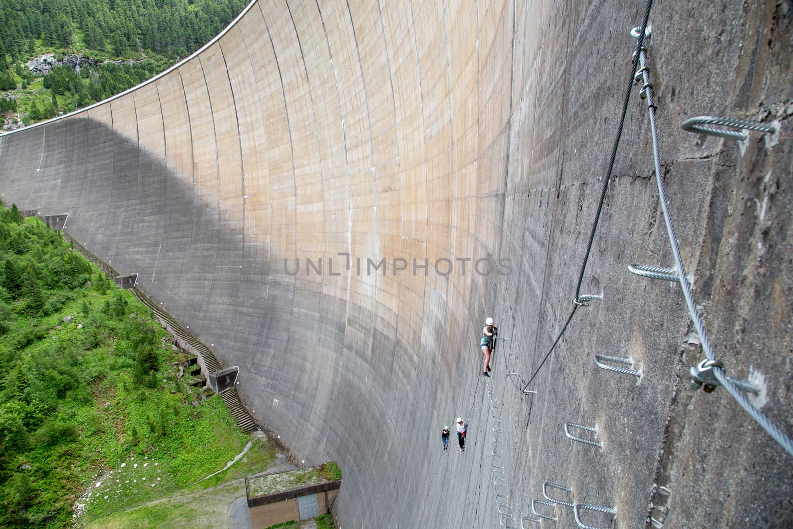 Finkenberg, Austria - June 9, 2018: Group of alpinists climbing the Via Ferrata on the Schlegeis Dam