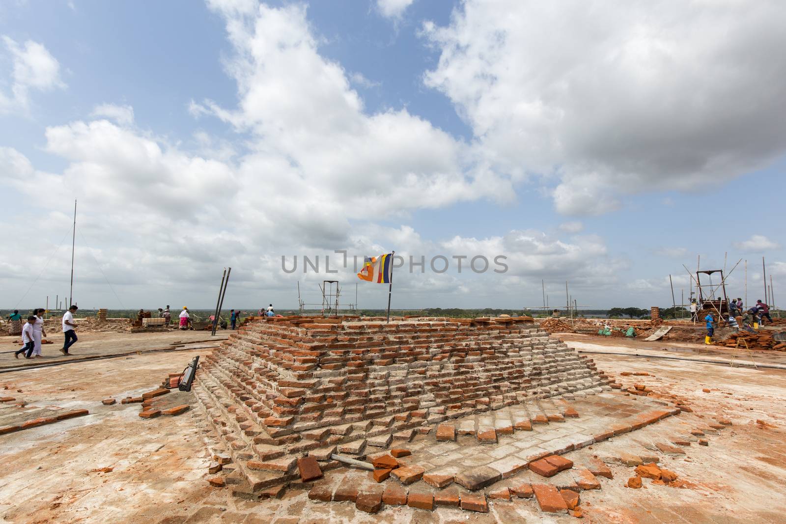 Anuradhapura, Sri Lanka - August 21, 2018: People working on top of Sandahiru Seya, the contruction sote a new stupa.