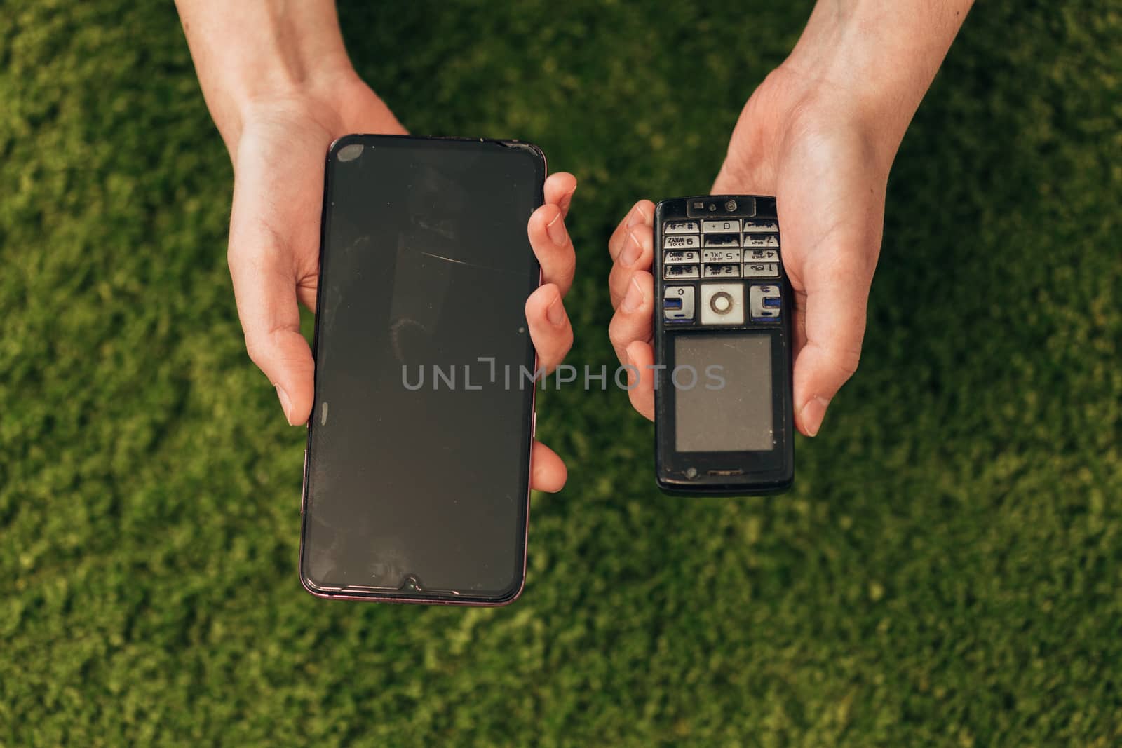 The Human Hand Choosing Phone That Lies Near New Smartphones by TrEKone