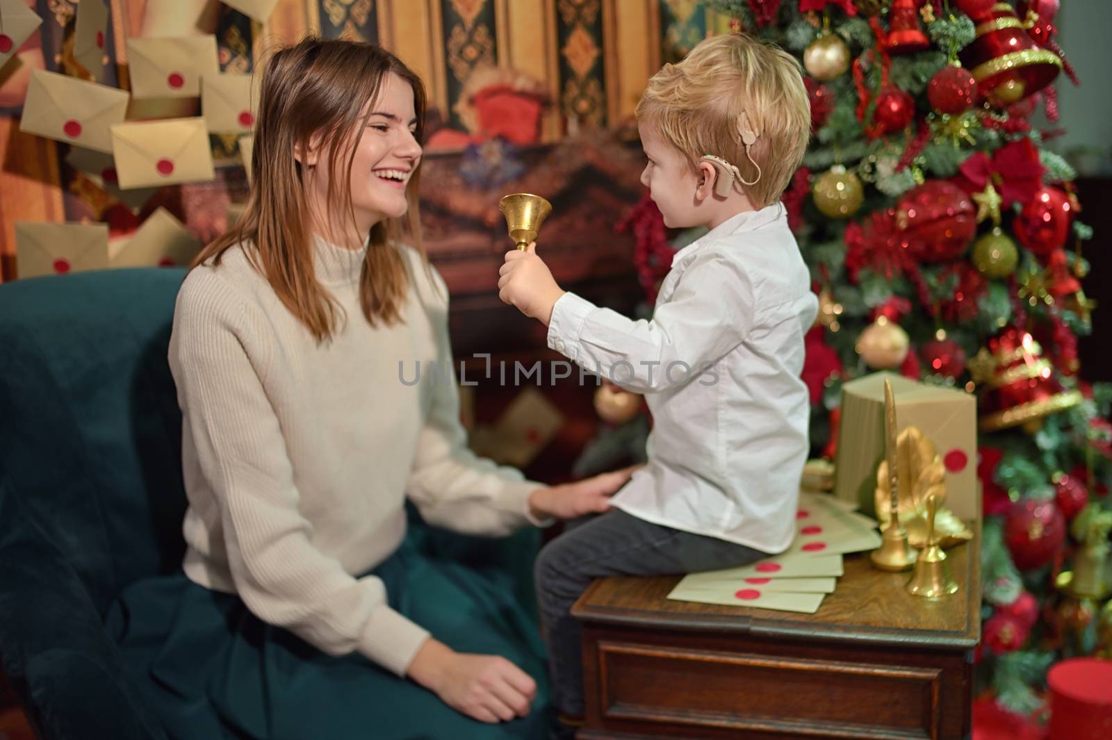 A Boy with Cochlear Implants play with Christmas Bell with his Mother