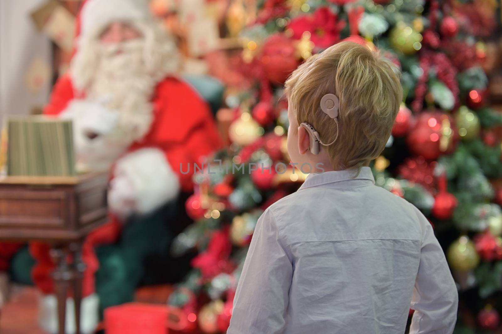 A Boy with Cochlear Implants and Santa Claus in Studio