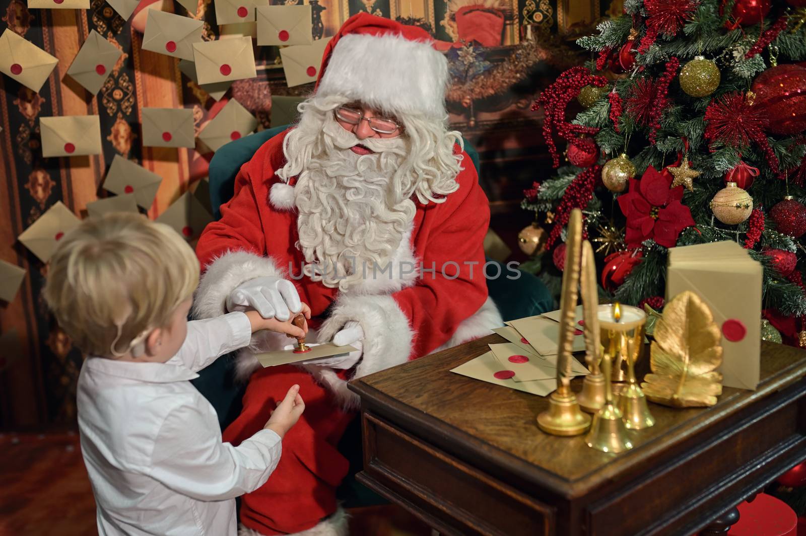 Boy with Cochlear Implants Seal Letter To Santa Claus For New Ye by mady70